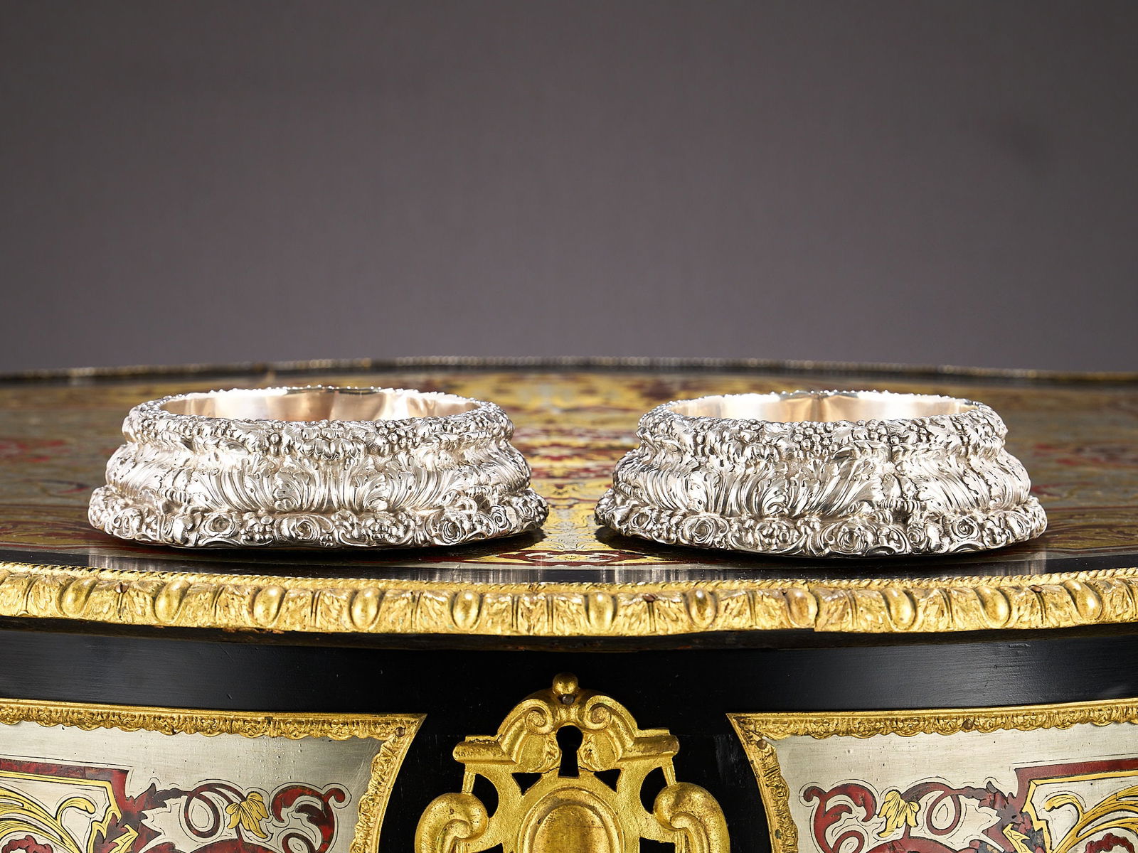 A PAIR OF GEORGE IV STERLING SILVER WINE COASTERS, SHEFFIELD 1830: A PAIR OF GEORGE IV STERLING SILVER WINE COASTERS, SHEFFIELD 1830 the 19th century wine coasters in the Rococo Revival style, of circular spreading shate and profusely decorated with vines and acanthu