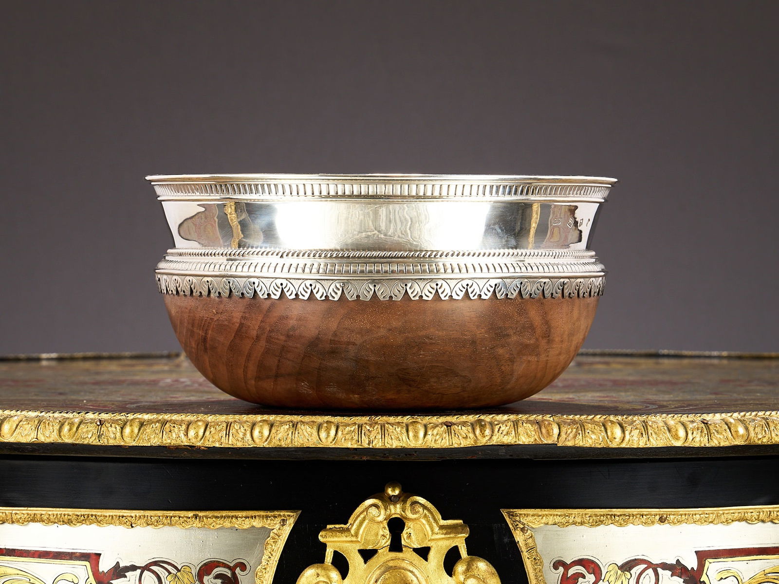 A MASSIVE STERLING SILVER AND WOOD MAZER STYLE BOWL: A MASSIVE STERLING SILVER AND WOOD MAZER STYLE BOWL of circular form, the silver mounts with rope twist and fluted borders, the interior silver lined, the base of wood, hallmarked London, 1972, Carrin