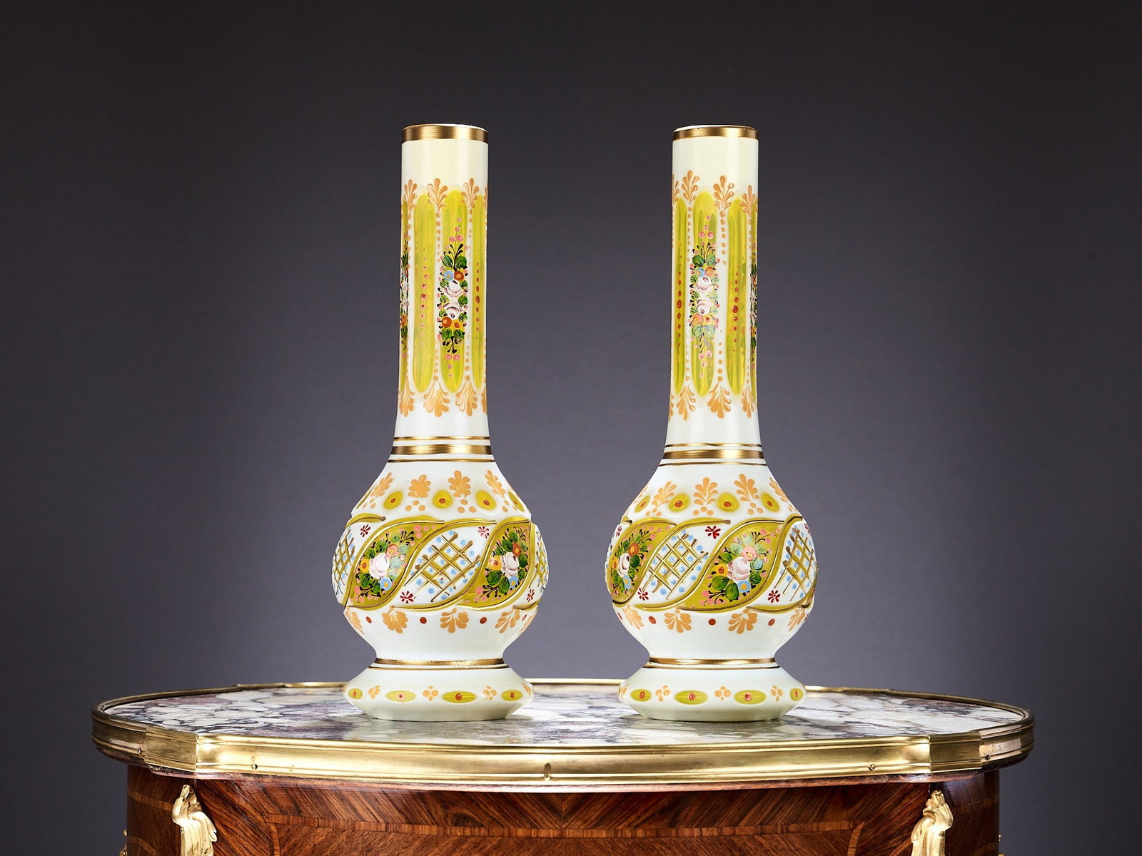 A PAIR OF BOHEMIAN FLASHED, ENAMELLED AND GILDED GLASS VASES FOR THE ISLAMIC MARKET: A PAIR OF BOHEMIAN FLASHED, ENAMELLED AND GILDED GLASS VASES FOR THE ISLAMIC MARKET of baluster form, with long necks with oval panels, white and yellow flashed glass, on circular feet, painted with f