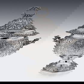 A MAGNIFICENT GEORGIAN STERLING SILVER SOUP TUREEN, C. 1827: A MAGNIFICENT GEORGIAN STERLING SILVER SOUP TUREEN, C. 1827 the George IV early 19th century solid silver tureen and cover of a monumental size and weight, of a round form mounted with a domed lid wit