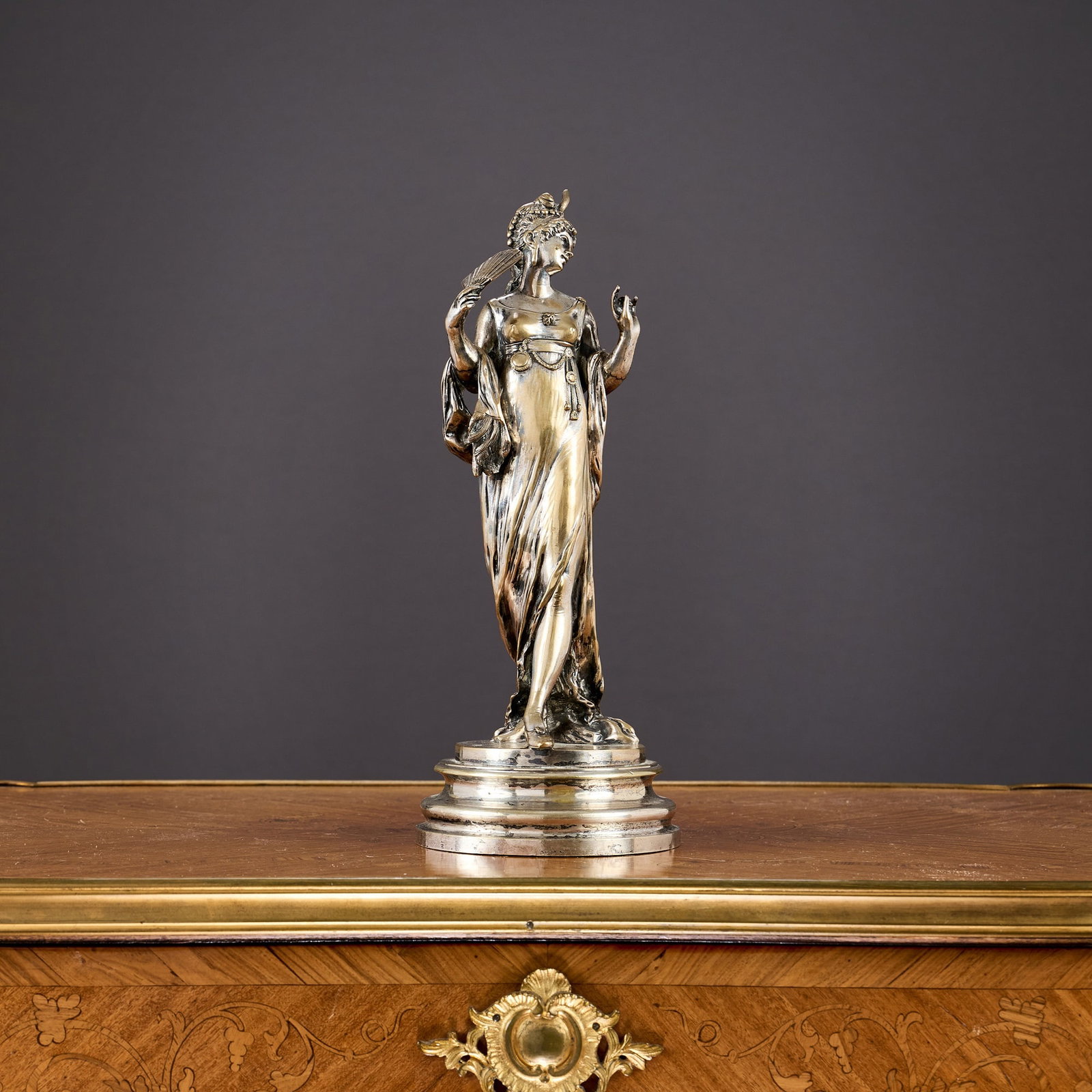 A 19TH CENTURY FRENCH SILVERED BRONZE FIGURE OF A LADY SIGNED A. LALOUETTE: A 19TH CENTURY FRENCH SILVERED BRONZE FIGURE OF A LADY SIGNED A. LALOUETTE the girl richly dressed in headdress, gown and holding a fan, on a stepped cylindrical base signed 'A. LALOUETTE', 28cm high
