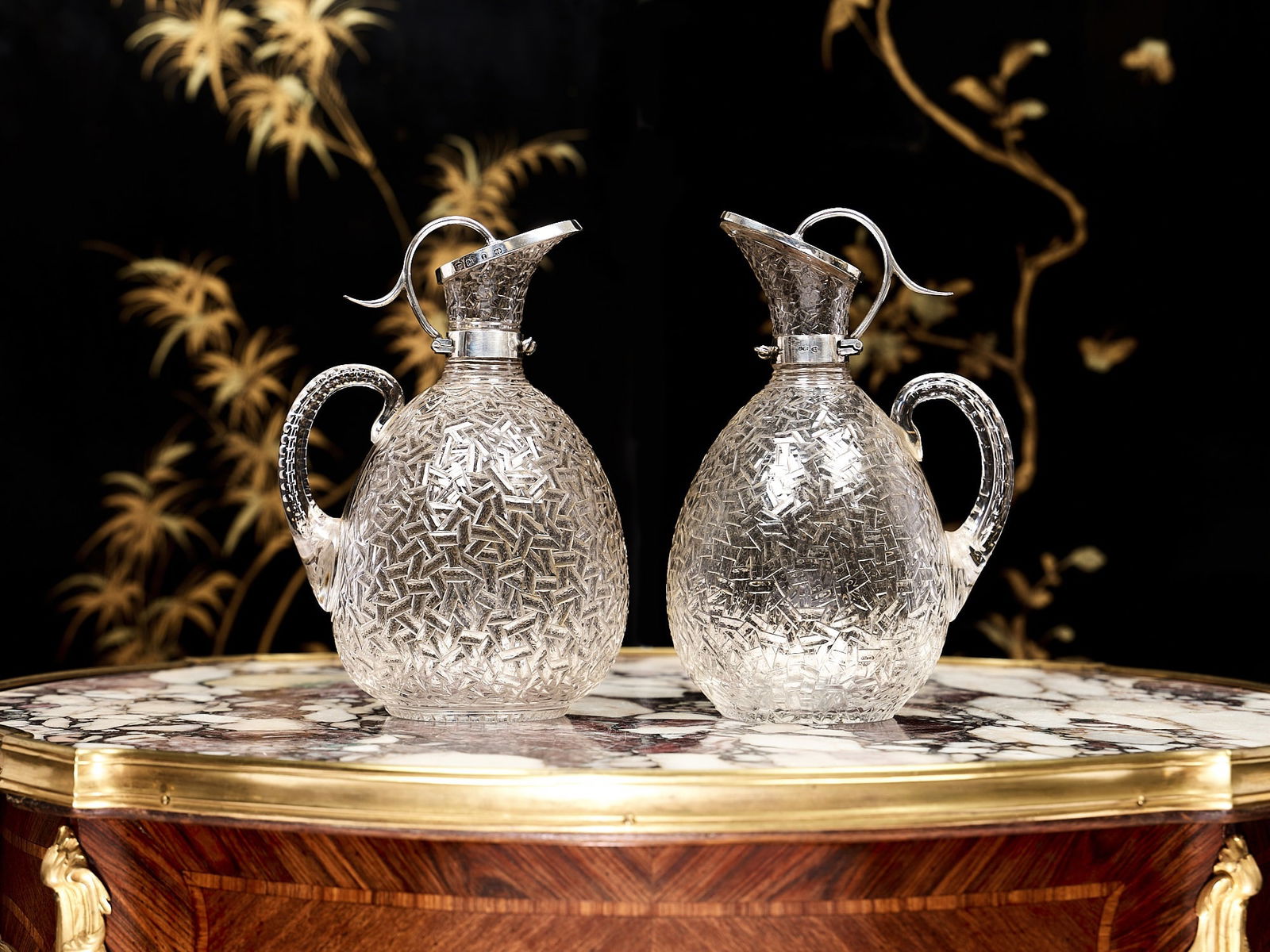 A PAIR OF VICTORIAN STERLING SILVER AND CUT GLASS CLARET JUGS, 1893, MAPPIN & WEBB: A PAIR OF VICTORIAN STERLING SILVER AND CUT GLASS CLARET JUGS, 1893, MAPPIN & WEBBlate 19th century, antique, the pair of wine jugs with integral glass handles, decorated with an unusual abstract patt