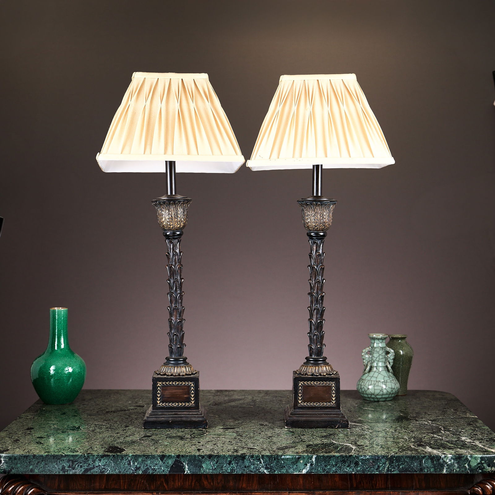 A PAIR OF REGENCY STYLE LAMP BASES: A PAIR OF REGENCY STYLE LAMP BASES modern, the table lamps with stems designed as palm leaves, with stiff leaf cast circular tops, on plinth bases, fitted for electricity, with shades, 77cm high inclu