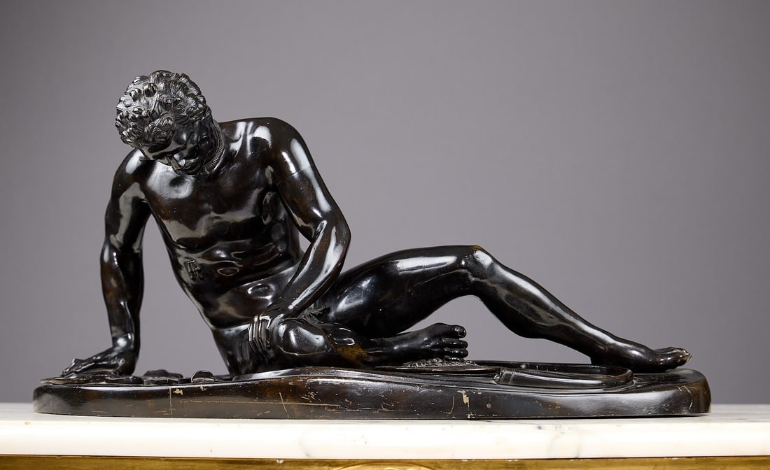 A LARGE 19TH CENTURY NEAPOLITAN BRONZE FIGURE OF THE DYING GAUL: A LARGE 19TH CENTURY NEAPOLITAN BRONZE FIGURE OF THE DYING GAUL the nude figure reclining on an oval base, dark brown patination, 66cm wide x 33cm high