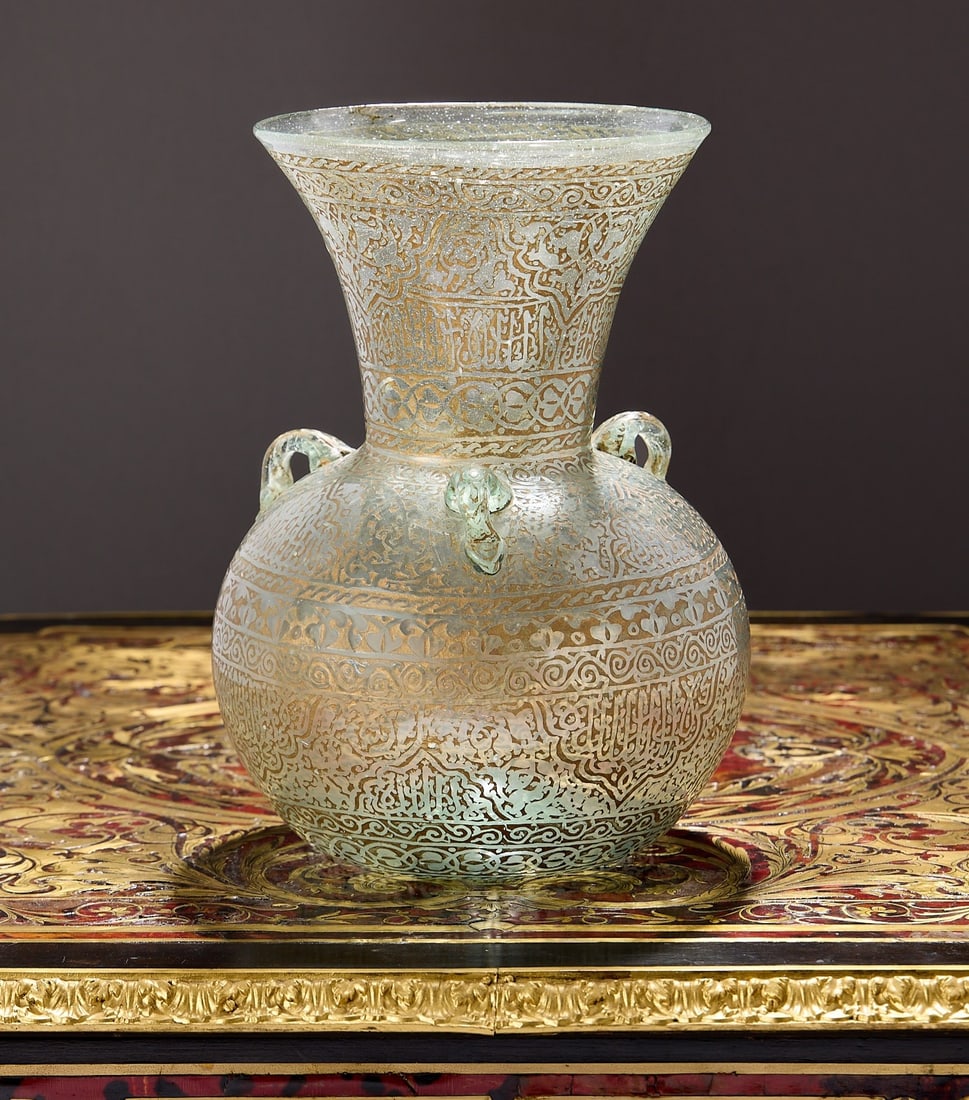 A 19TH CENTURY SYRIAN GLASS MOSQUE LAMP: A 19TH CENTURY SYRIAN GLASS MOSQUE LAMP Syrian or Egyptian, of typical form with three lug handles to the shoulders, with long flared neck, the body richly decorated throughout with etched work of ara