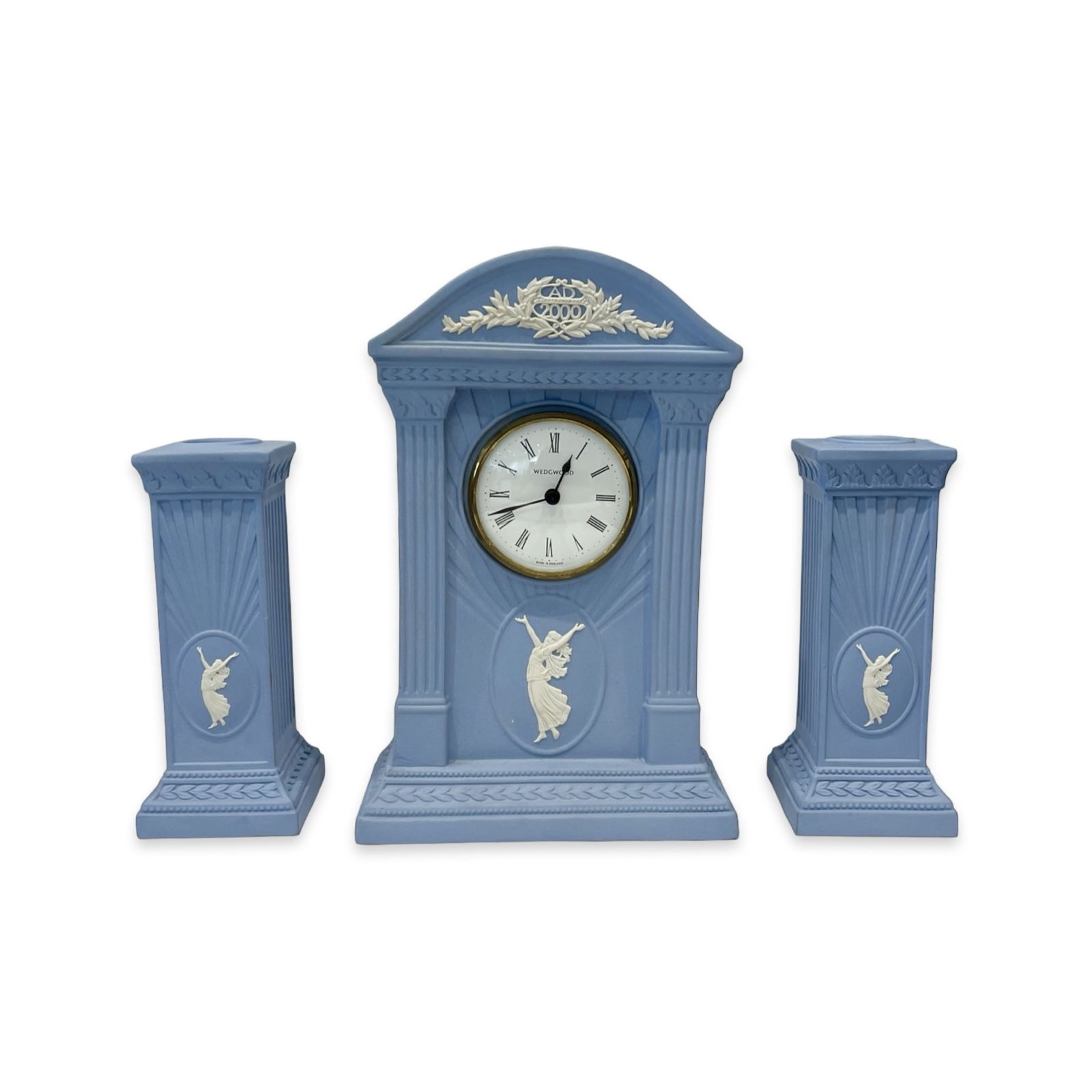 A WEDGWOOD JASPER WARE CLOCK GARNITURE: A WEDGWOOD JASPER WARE CLOCK GARNITURE the modern clock set comprising mantel clock with dial signed 'WEDGWOOD', and a pair of candlesticks, in blue and white, the clock 22cm high (3)