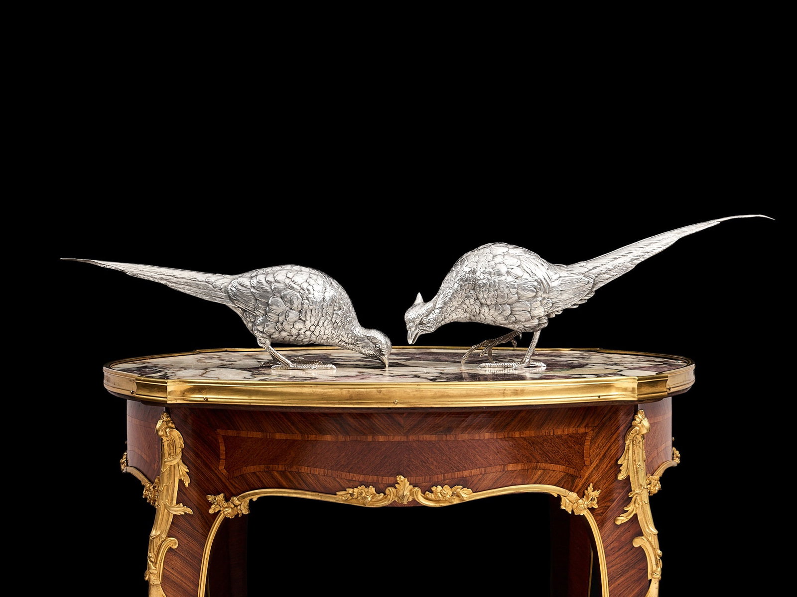 A FINE PAIR OF AMERICAN STERLING SILVER PHEASANTS, MARSHALL FIELD & CO.: A FINE PAIR OF AMERICAN STERLING SILVER PHEASANTS, MARSHALL FIELD & CO. the models of pheasants in the naturalistic style, depicting a cock and hen bird, their tails marked STERLING / MARSHALL FIE