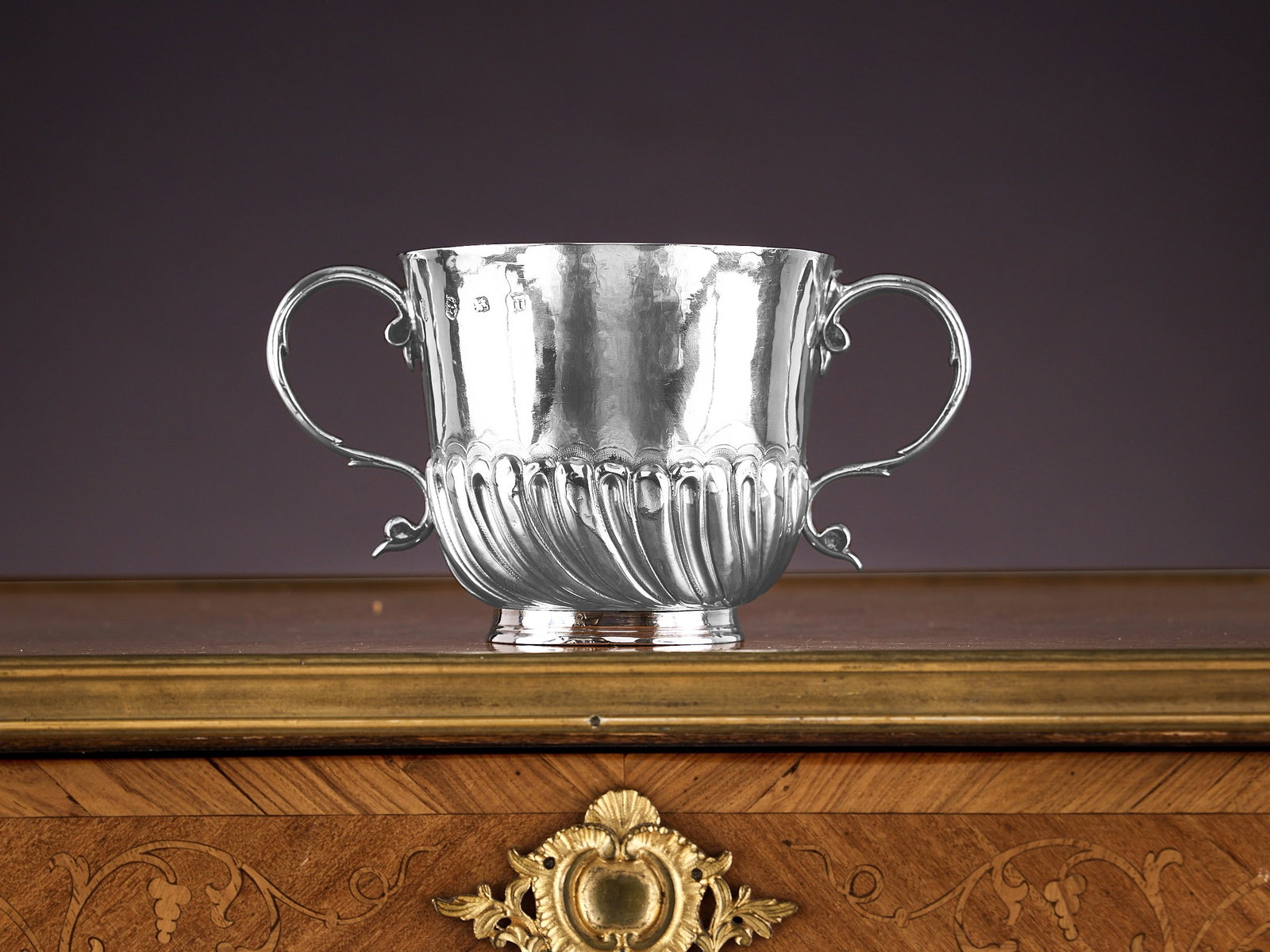 A RARE WILLIAM AND MARY STERLING SILVER PORRINGER C.1689: A RARE WILLIAM AND MARY STERLING SILVER PORRINGER C.1689 the 17th century porringer cup with a pair of scroll handles, the bowl with gadrooned base, on circular foot, hallmarked London, 1689, 350g (11