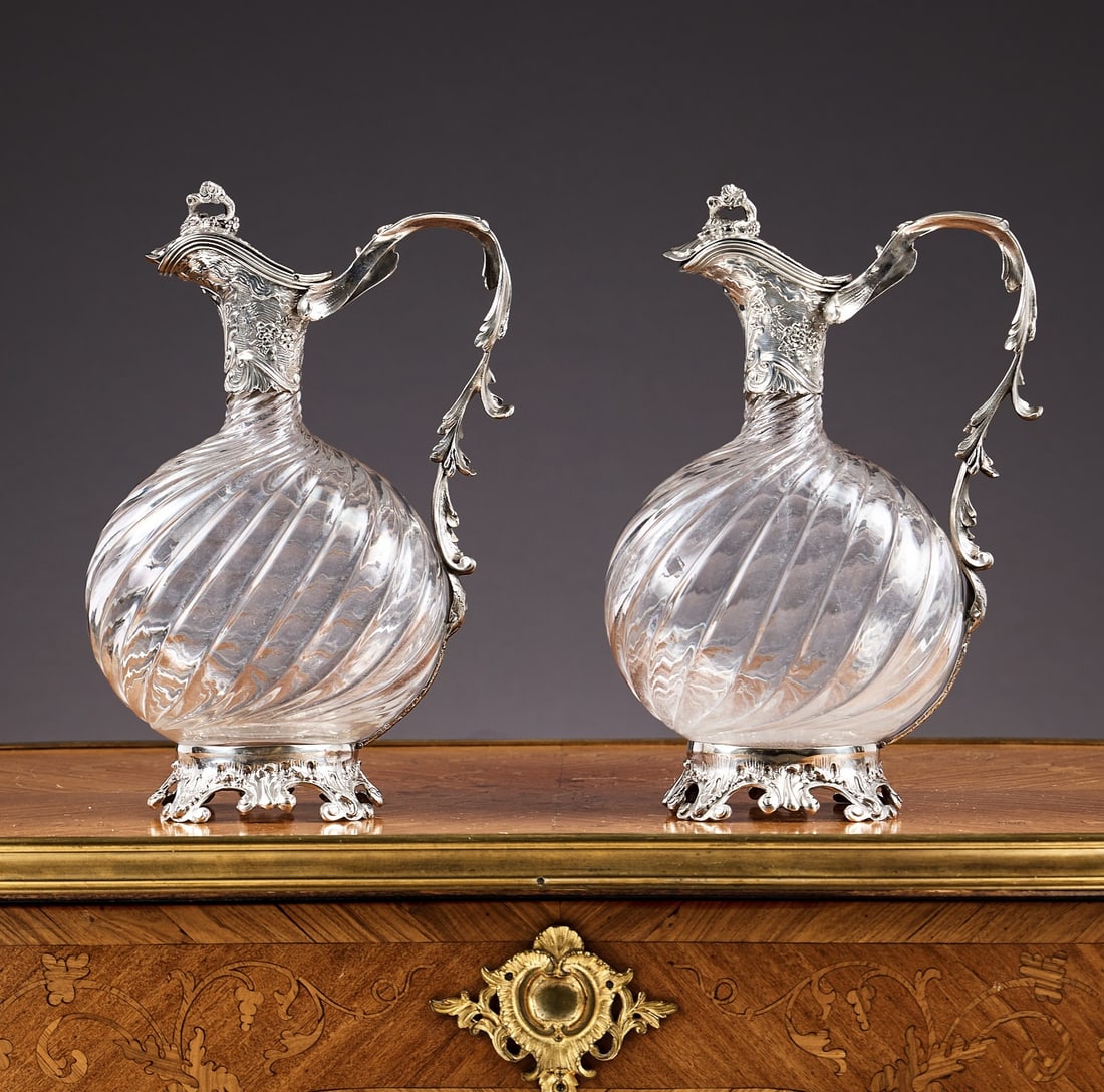 A FINE PAIR OF LATE 19TH CENTURY FRENCH SILVER AND GLASS CLARET JUGS: A FINE PAIR OF LATE 19TH CENTURY FRENCH SILVER AND GLASS CLARET JUGS the wine jugs / ewers in the manner of Tetard Freres, with handles designed as trailing acanthus leaves, the hinged covers with vin
