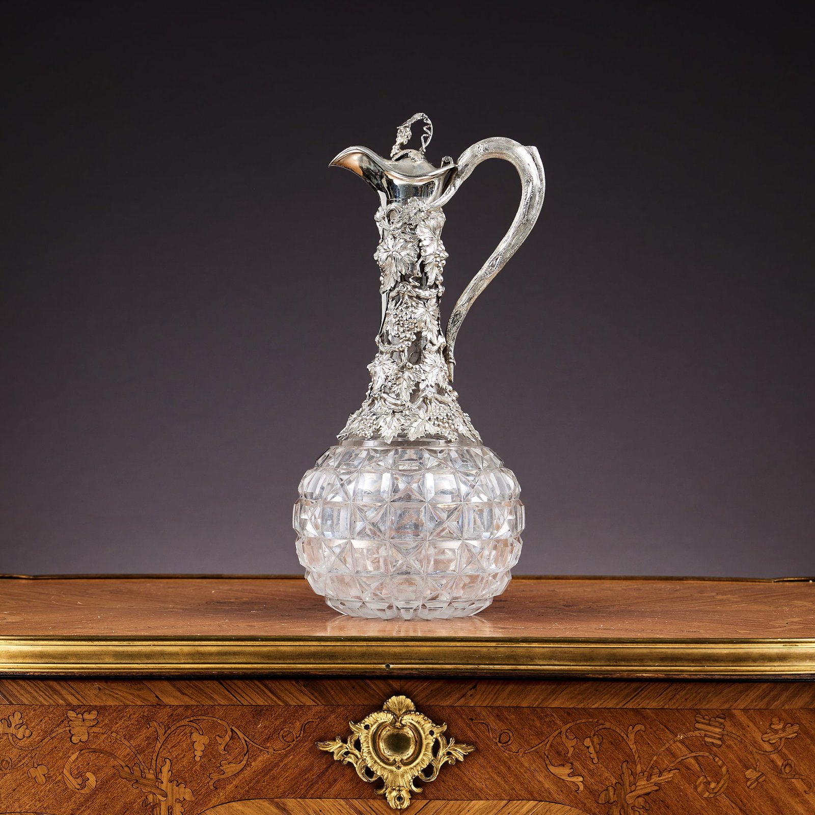 A FINE MID 19TH CENTURY STERLING SILVER AND GLASS VINE AND GRAPE CLARET JUG, C.1865: A FINE MID 19TH CENTURY STERLING SILVER AND GLASS VINE AND GRAPE CLARET JUG, C.1865 the Victorian antique wine jug with silver mounts, the scroll handle naturalistically designed as a vine, the neck w
