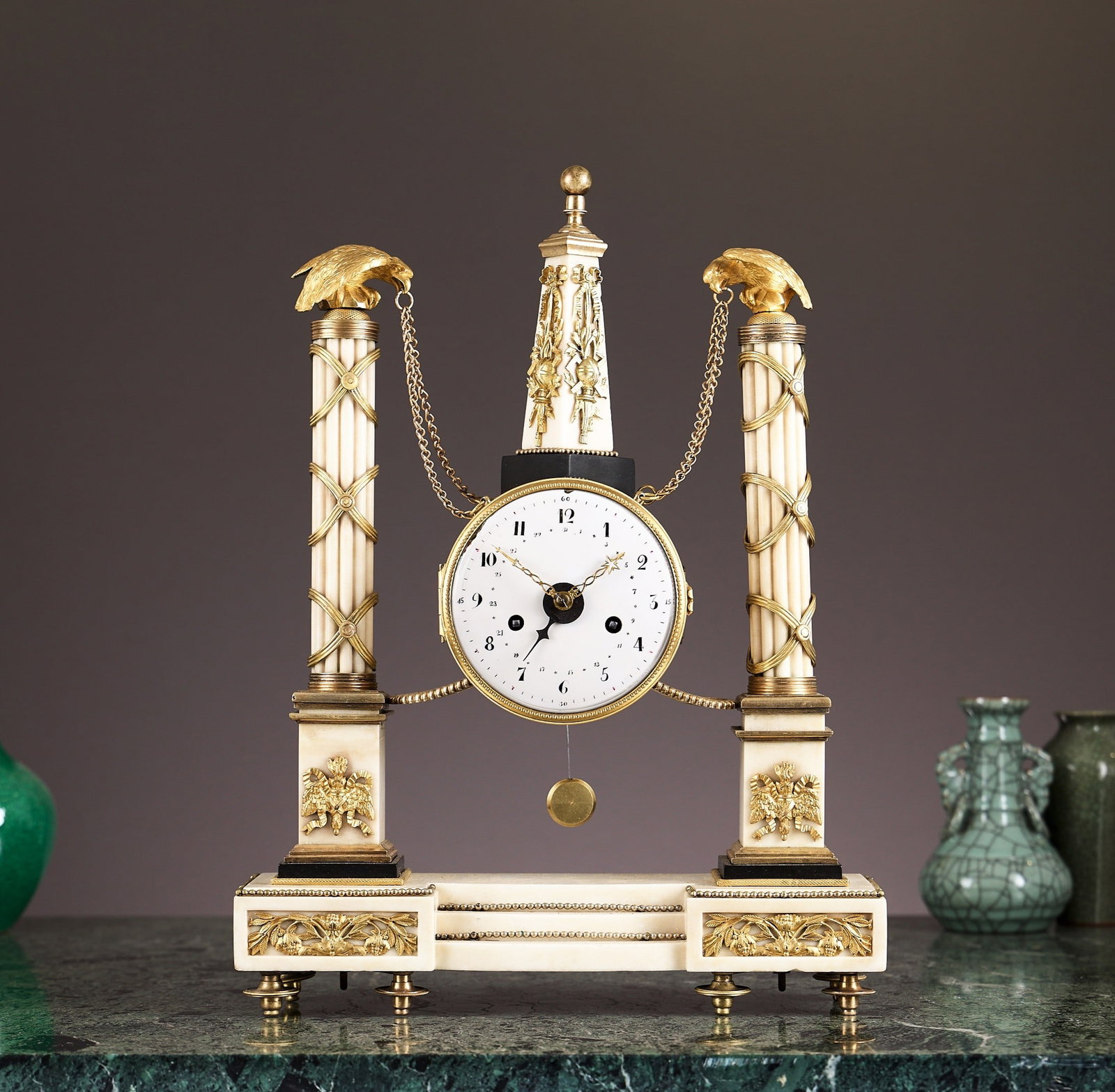 AN EARLY 19TH CENTURY FRENCH MARBLE OBELISK PORTICO CLOCK: AN EARLY 19TH CENTURY FRENCH MARBLE OBELISK PORTICO CLOCK in the Louis XVI style, the case sumounted by a marble and ormolu mounted obelisk and hung from a pair of fluted cylindrical columns with gilt