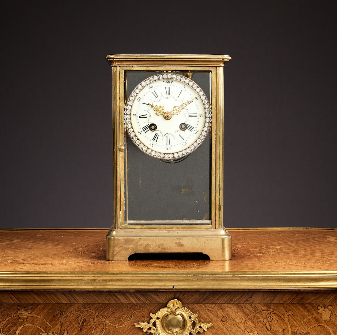 A LATE 19TH CENTURY FRENCH FOUR GLASS MANTEL CLOCK WITH PASTE SET BEZEL: A LATE 19TH CENTURY FRENCH FOUR GLASS MANTEL CLOCK WITH PASTE SET BEZEL the paste set bezel enclosing the white enamelled dial with Roman and Arabic numerals, the twin barrel movement striking on a co
