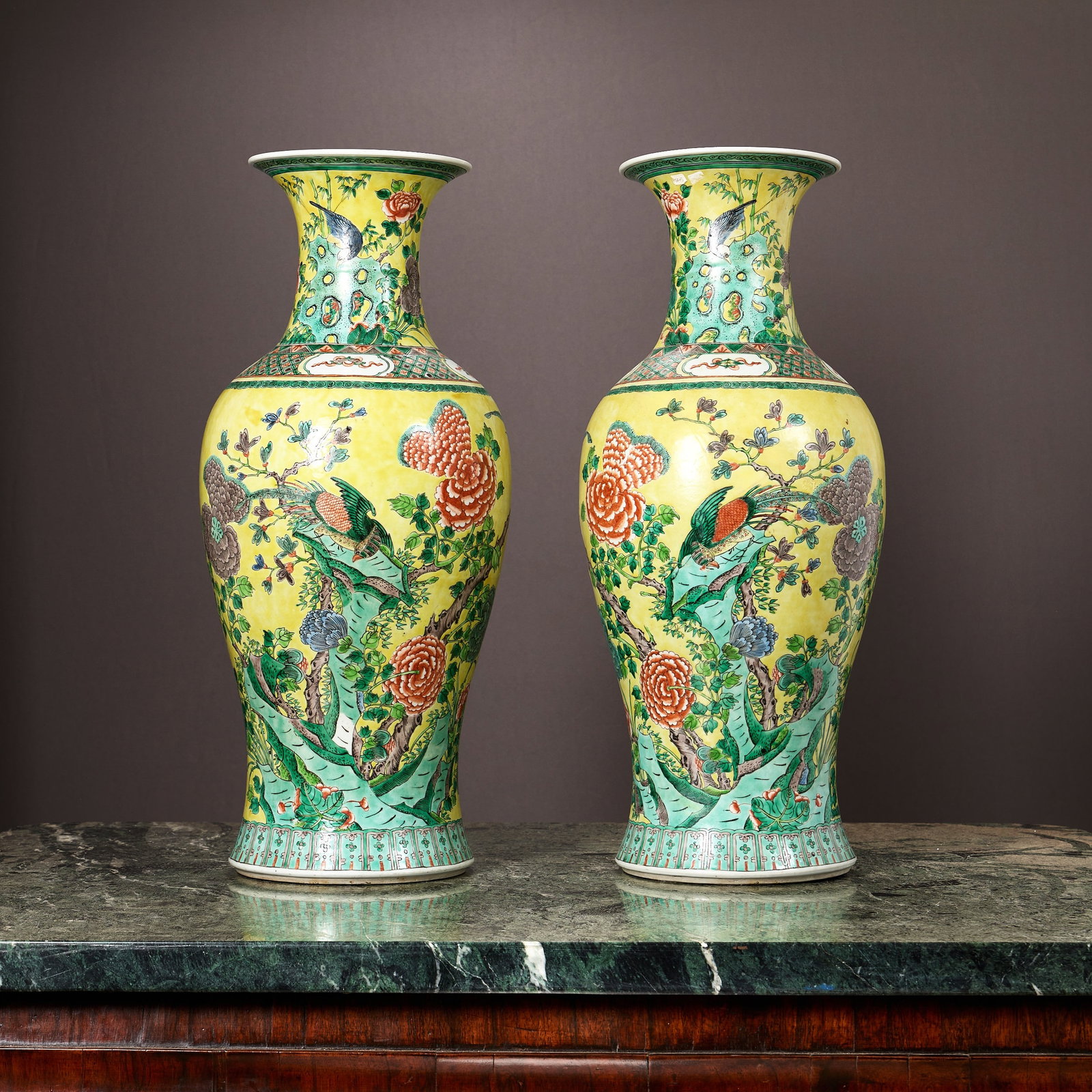 A PAIR OF CHINESE PORCELAIN YELLOW BALUSTER VASES: A PAIR OF CHINESE PORCELAIN YELLOW BALUSTER VASES decorated with exotic birds amongst blossom on a yellow ground, unmarked, 60cm high (2)