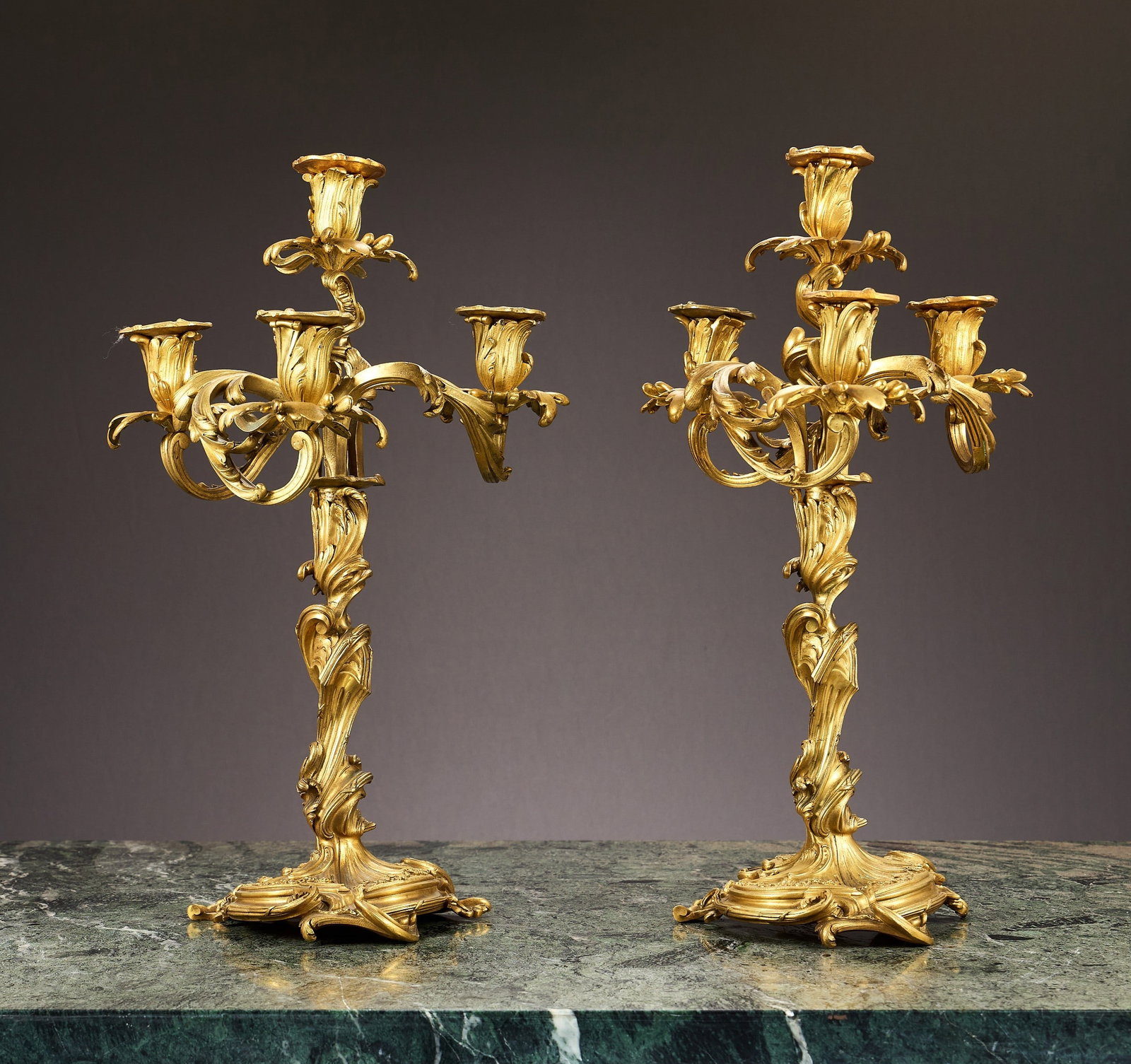 A FINE PAIR OF 19TH CENTURY FRENCH GILT BRONZE CANDELABRA AFTER MEISSONIER: A FINE PAIR OF 19TH CENTURY FRENCH GILT BRONZE CANDELABRA AFTER MEISSONIER in the Rococo style, the ormolu candelabra formed as candlesticks each with a removable section of four branches above, the a