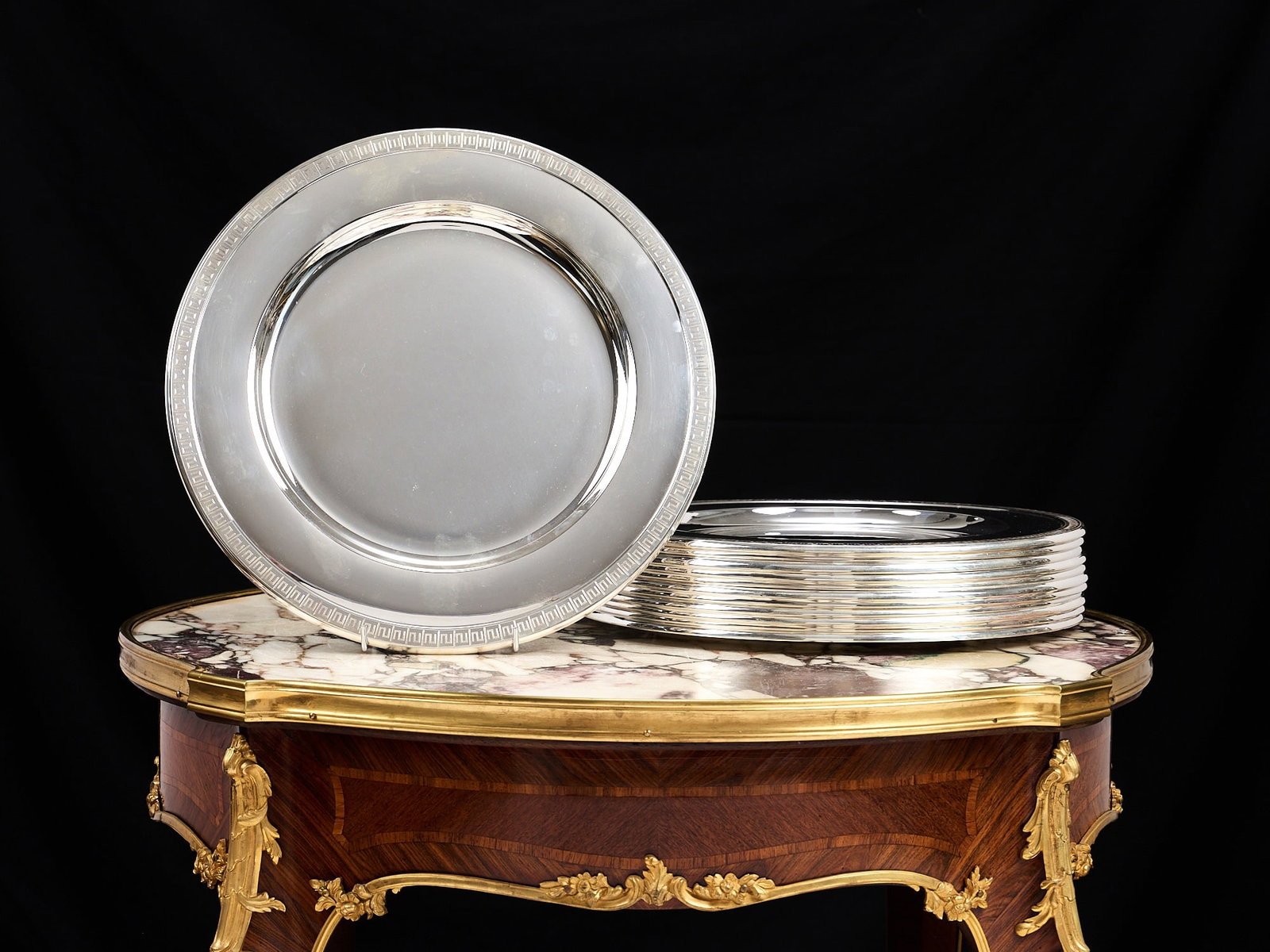 A SET OF TWELVE NORWEGIAN SOLID SILVER UNDERPLATES: A SET OF TWELVE NORWEGIAN SOLID SILVER UNDERPLATES the twelve solid silver Scandinavian circular dishes or lay plates with recessed circular centres, each with a greek key border to the rim, marked wi