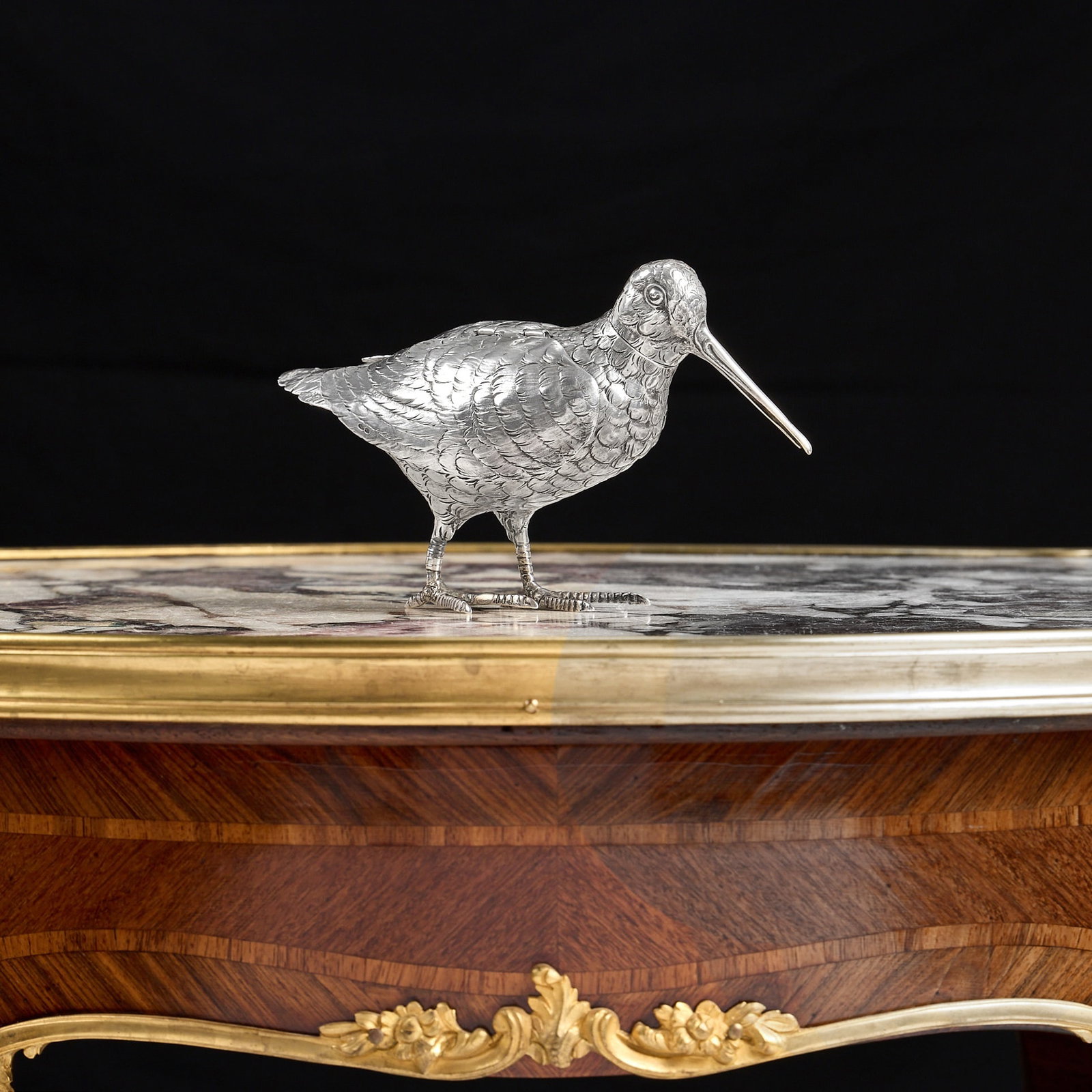 AN EARLY 20TH CENTURY STERLING SILVER MODEL OF A SNIPE, IMPORT MARKS FOR LONDON, 1912: AN EARLY 20TH CENTURY STERLING SILVER MODEL OF A SNIPE, IMPORT MARKS FOR LONDON, 1912 the George V period antique model of a game bird with articulated, hinged wings, the head detachable, the body nat