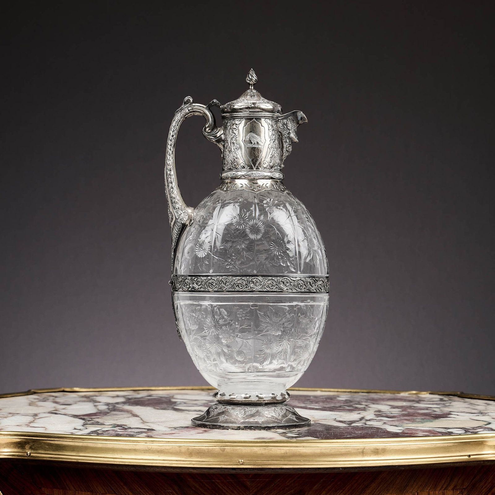 A FINE 19TH CENTURY SILVER GILT AND ROCK CRYSTAL STYLE GLASS CLARET JUG, CHARLES EDWARDS: A FINE 19TH CENTURY SILVER GILT AND ROCK CRYSTAL STYLE GLASS CLARET JUG, CHARLES EDWARDS the Victorian sterling silver gilt mounted crystal glass wine jug in the Renaissance Revival style, the scroll 