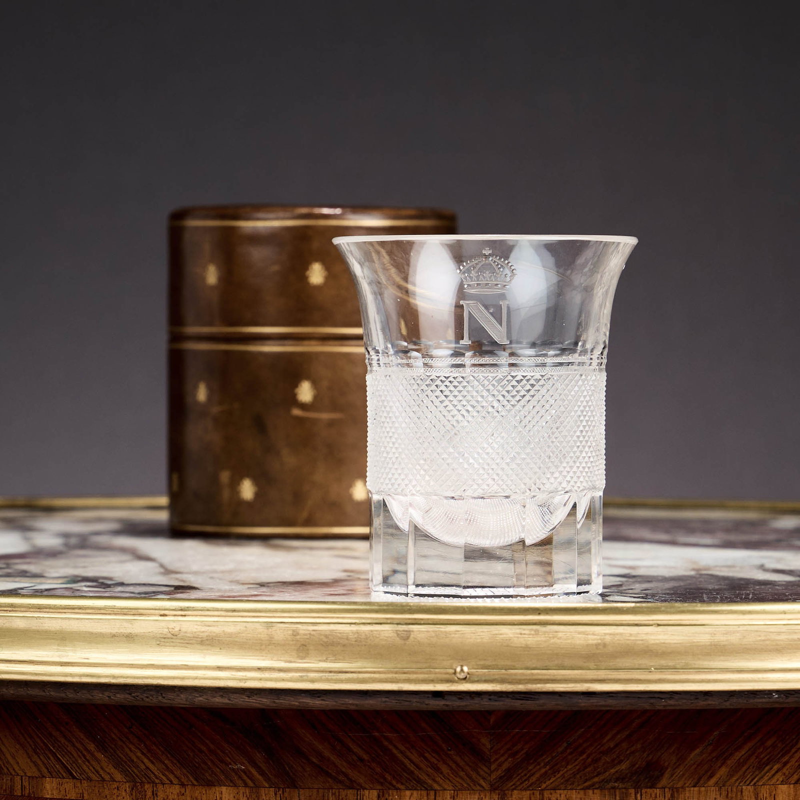 A FINE CUT AND ENGRAVED GLASS TUMBLER OF NAPOLEONIC INTEREST, PROBABLY C. 1903: A FINE CUT AND ENGRAVED GLASS TUMBLER OF NAPOLEONIC INTEREST, PROBABLY C. 1903 Attributed to J & L Lobmeyr, of cylindrical form with a flared rim, cut with a wide central band of mitre diamonds an