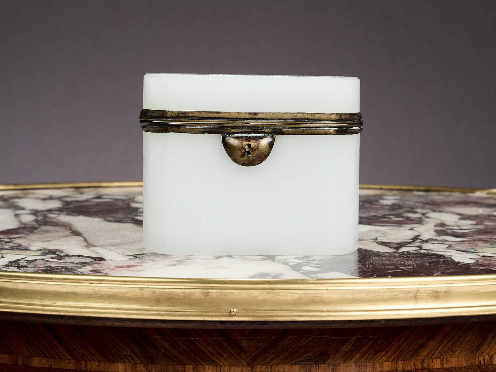 A FRENCH OPALINE GLASS AND ORMOLU MOUNTED CASKET: A FRENCH OPALINE GLASS AND ORMOLU MOUNTED CASKET the jewellery box with hinged bevelled edged glass lid with ormolu mounts, of rectangular form with curved sides, 12cm wide