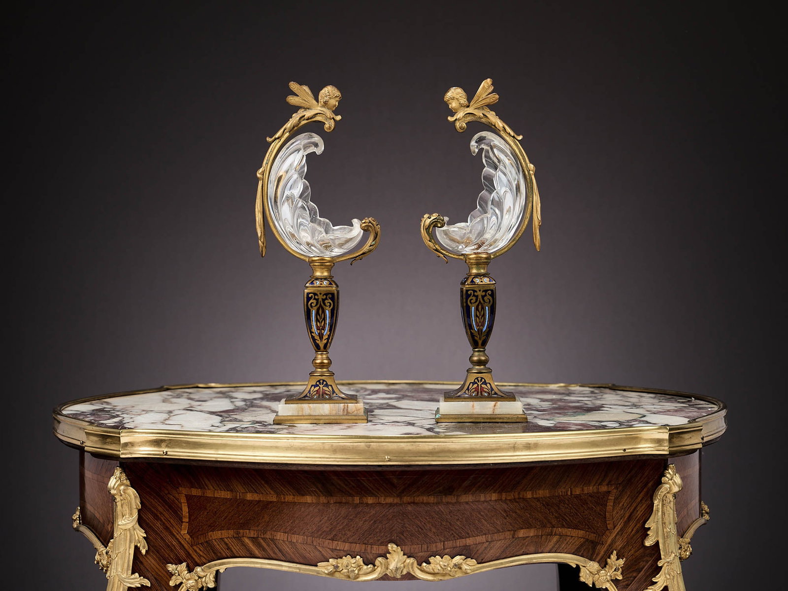 A PAIR OF LATE 19TH CENTURY CHAMPLEVE ENAMEL AND FAUX ROCK CRYSTAL VASES: A PAIR OF LATE 19TH CENTURY CHAMPLEVE ENAMEL AND FAUX ROCK CRYSTAL VASES French, in the manner of Barbedienne, the heavy cut crystal glass shell shaped bowls designed to resemble rock crystal, raised 