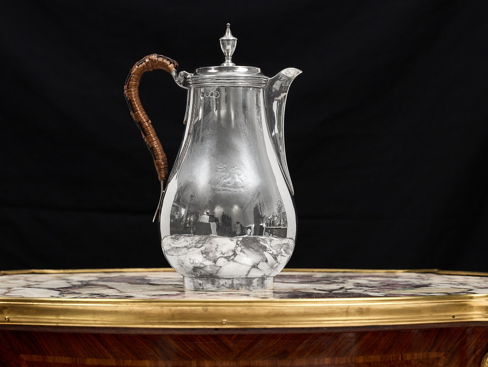 A GEORGE III STERLING SILVER COFFEE POT, LONDON, C. 1791: A GEORGE III STERLING SILVER COFFEE POT, LONDON, C. 1791 the late 18th century Georgian silver coffee pot or hot water jug engraved with a crowned lion to the body, with wicker scroll handle, the circ