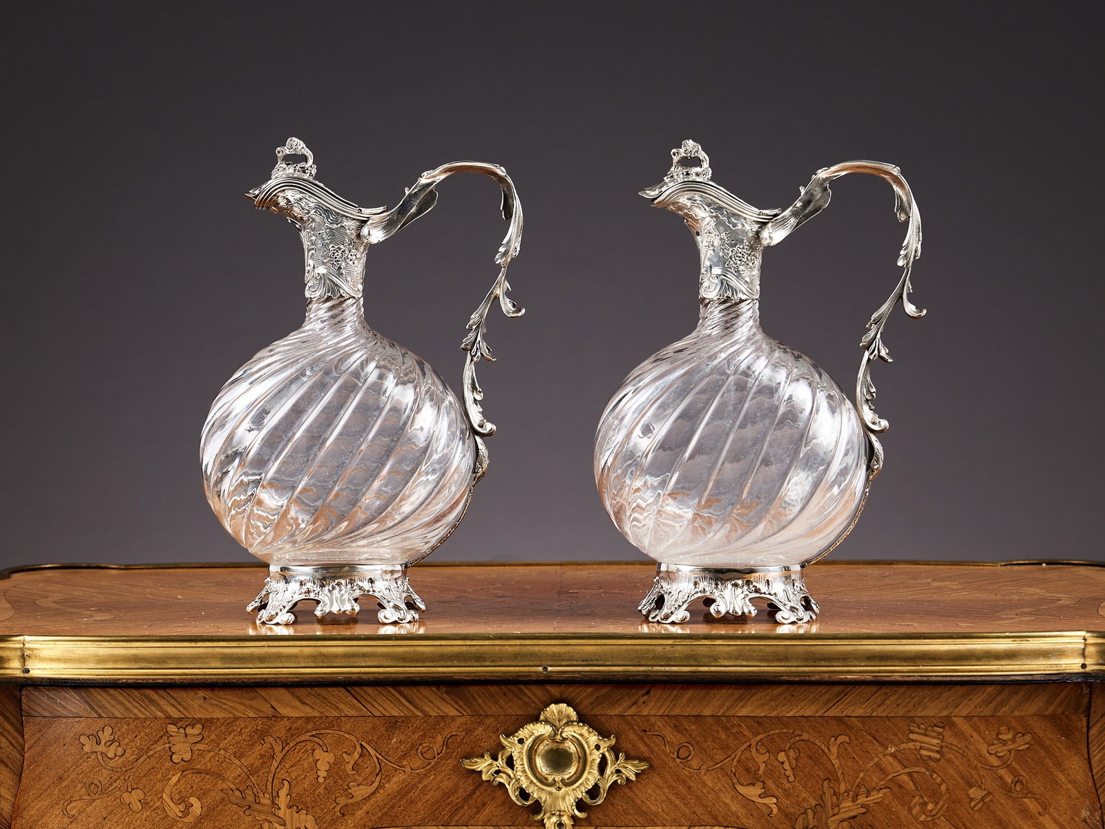 A FINE PAIR OF LATE 19TH CENTURY FRENCH SILVER AND GLASS CLARET JUGS: A FINE PAIR OF LATE 19TH CENTURY FRENCH SILVER AND GLASS CLARET JUGS the wine jugs / ewers in the manner of Tetard Freres, with handles designed as trailing acanthus leaves, the hinged covers with vin