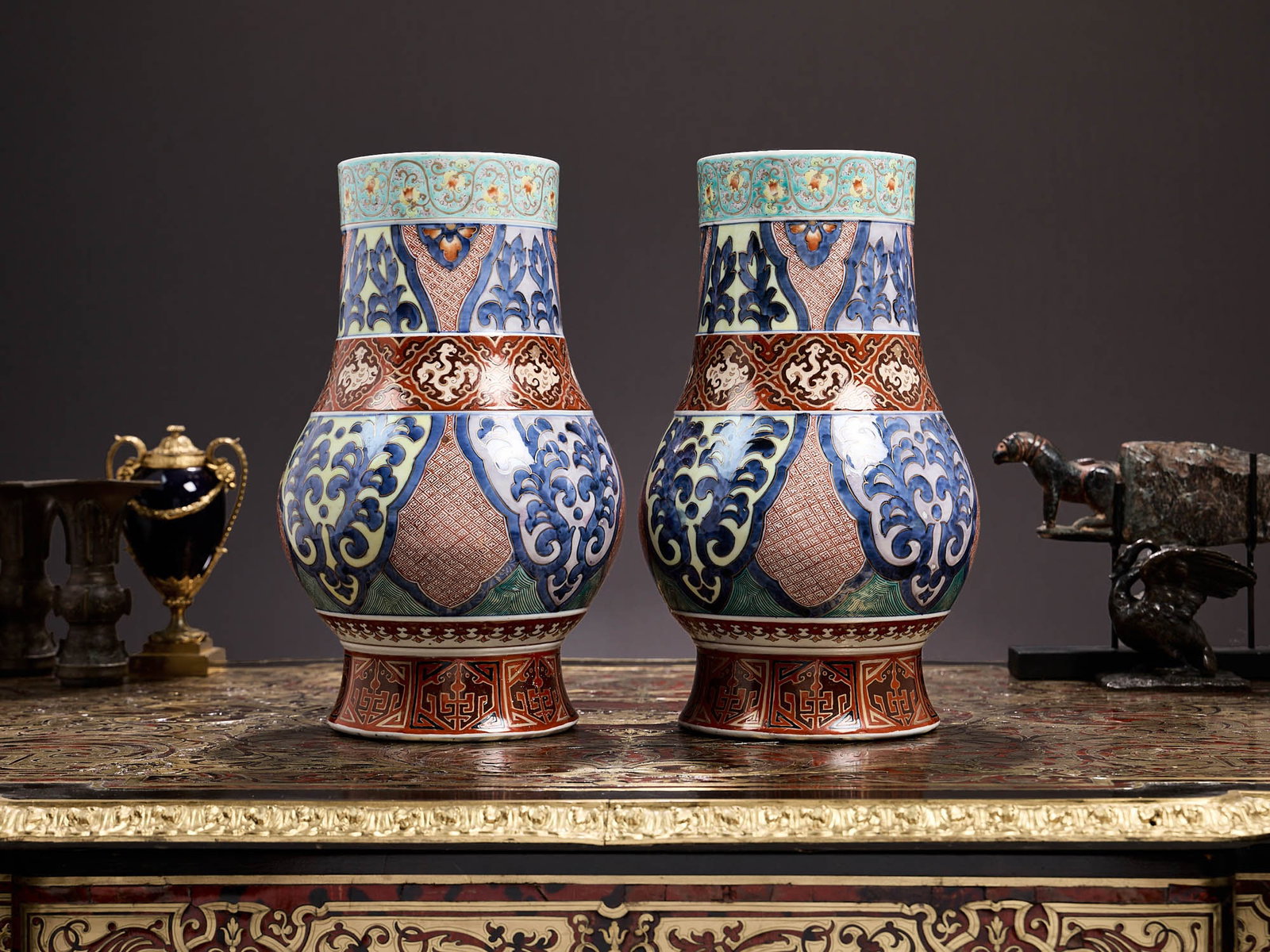 A PAIR OF JAPANESE MEIJI PERIOD KUTANI NANRI PORCELAIN VASES: A PAIR OF JAPANESE MEIJI PERIOD KUTANI NANRI PORCELAIN VASES of baluster form on spreading, circular feet, decorated with a band of birds within quatrefoils to the body and scrolling floral tendrils o
