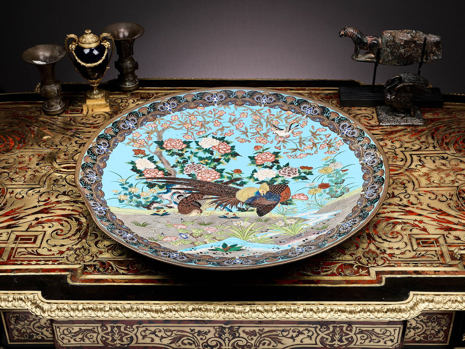 A LARGE JAPANESE MEIJI PERIOD CLOISONNE ENAMEL CHARGER: A LARGE JAPANESE MEIJI PERIOD CLOISONNE ENAMEL CHARGER 19th centur, the very large circular dish decorated with golden pheasants and peonies on a bright blue enamel ground, flanked by a border of styl