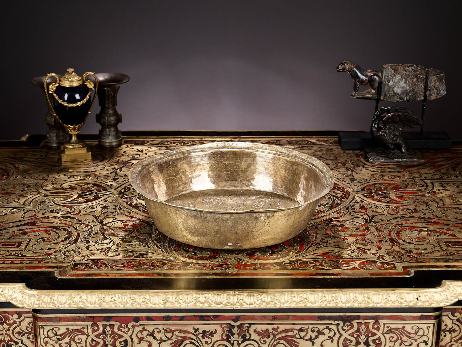 AN 18TH CENTURY OTTOMAN HAMMAM TOMBAK (BOWL), TURKEY: AN 18TH CENTURY OTTOMAN HAMMAM TOMBAK (BOWL), TURKEY the gilt brass circular basin engraved with strapwork and arabesques, 34.5cm diameter x 9cm high