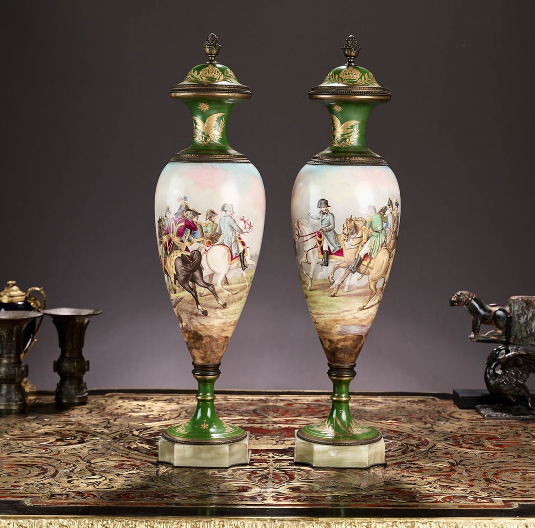 A FINE PAIR OF 19TH CENTURY SEVRES STYLE PORCELAIN URNS WITH NAPOLEONIC SCENES: A FINE PAIR OF 19TH CENTURY SEVRES STYLE PORCELAIN URNS WITH NAPOLEONIC SCENES the urns and covers in the 18th century Louis XVI style, the bodies painted with a continuous band depicting Napoleonic b
