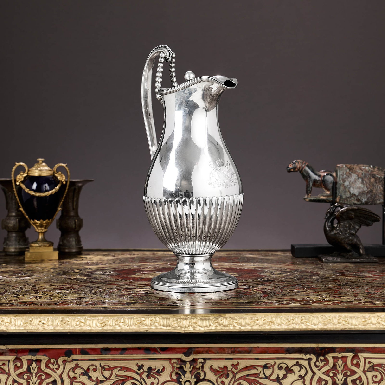 A VERY LARGE GEORGE III STERLING SILVER BEER JUG C.1799, CREST OF EARL OF EDGCUMBE: A VERY LARGE GEORGE III STERLING SILVER BEER JUG C.1799, CREST OF EARL OF EDGCUMBE the large 18th century Georgian water pitcher or beer jug of unusual design, with gadrooned base and raised on a dome
