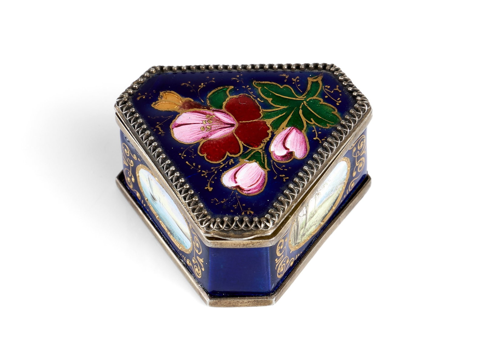 A LATE 19TH CENTURY AUSTRIAN ENAMEL AND SILVER TRIANGULAR PILL BOX: A LATE 19TH CENTURY AUSTRIAN ENAMEL AND SILVER TRIANGULAR PILL BOX the hinged cover enamelled with a floral sprig on dark blue ground, the three sides painted with detailed landscapes, the underside w