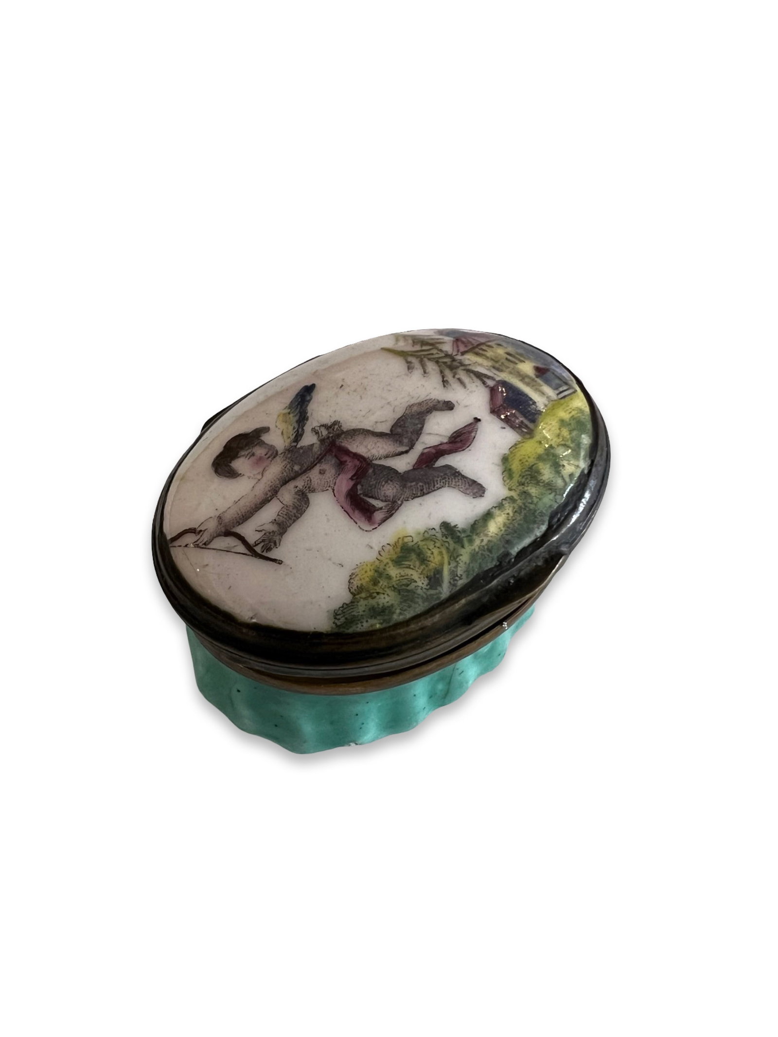 A LATE 18TH CENTURY BILSTON ENAMEL PATCH BOX DECORATED WITH CUPID: A LATE 18TH CENTURY BILSTON ENAMEL PATCH BOX DECORATED WITH CUPID the South Staffordshire George III period box with hinged cover depicting a flying cherub with bow and a temple to the background, of 