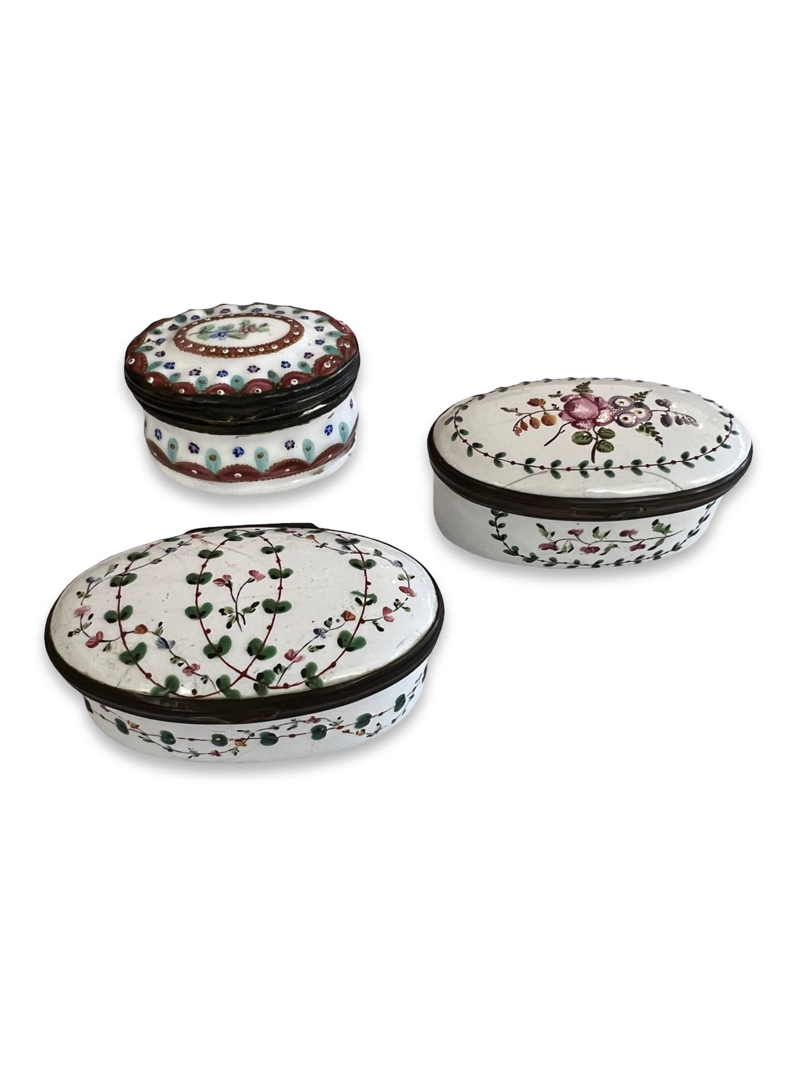 THREE 18TH CENTURY BILSTON ENAMEL BOXES WITH FLORAL DECORATION: THREE 18TH CENTURY BILSTON ENAMEL BOXES WITH FLORAL DECORATION all George III period, South Staffordshire, with floral and foliate motifs on white ground, the largest 6cm wide