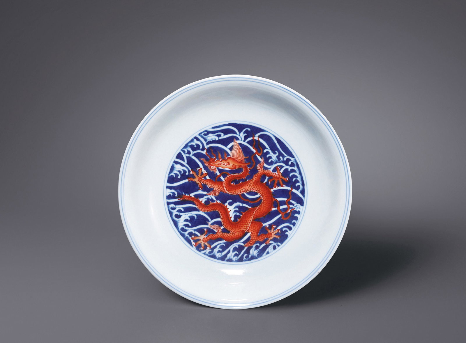 A BLUE AND WHITE IRON-RED 'DRAGON AND WAVES' DISH Seal Mark and Period of Qianlong, Qing Dynasty (1 of 2)