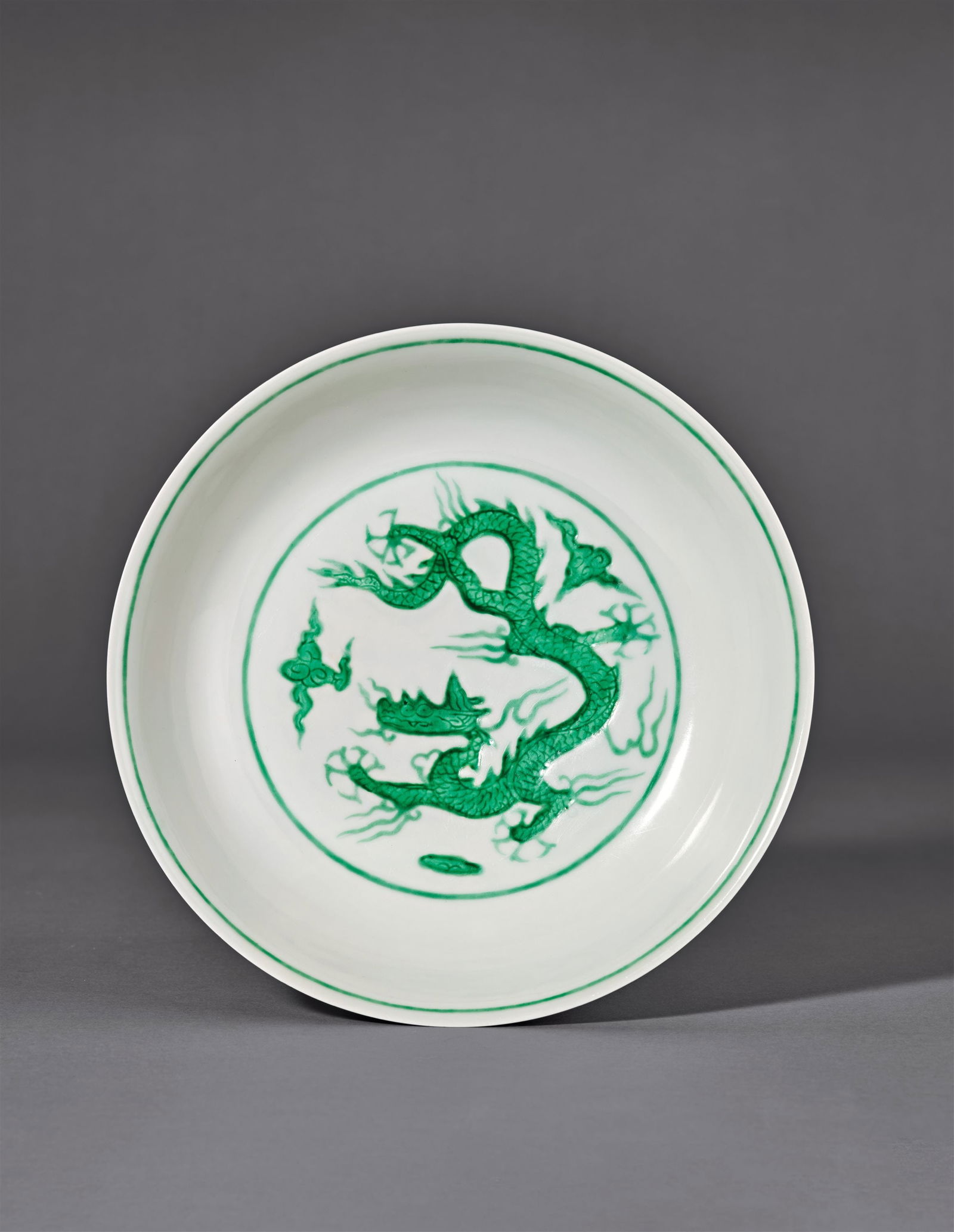 AN INCISED WHITE-GLAZED GREENCLOUD-AND-DRAGON DISH: Mark and Period of Hongzhi, Ming Dynasty