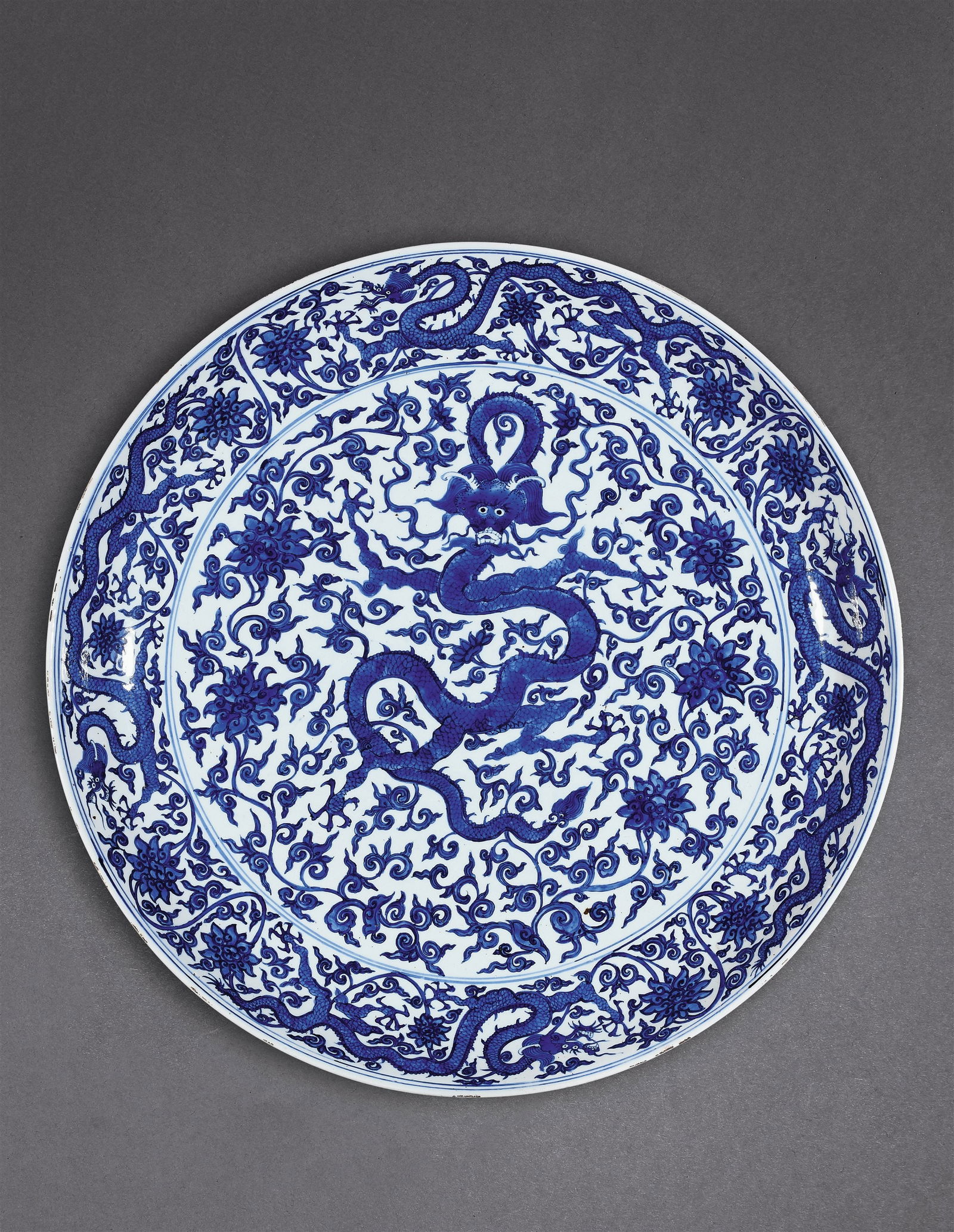A LARGE BLUE-AND-WHITE DISH WITH DRAGONS AND LOTUS SCROLLS (1 of 1)