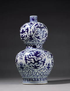 A BLUE-AND-WHITE GOURD VASE WITH DRAGON, CRANE AND PHOENIX: Mark and Period of Jiajing, Ming Dynasty