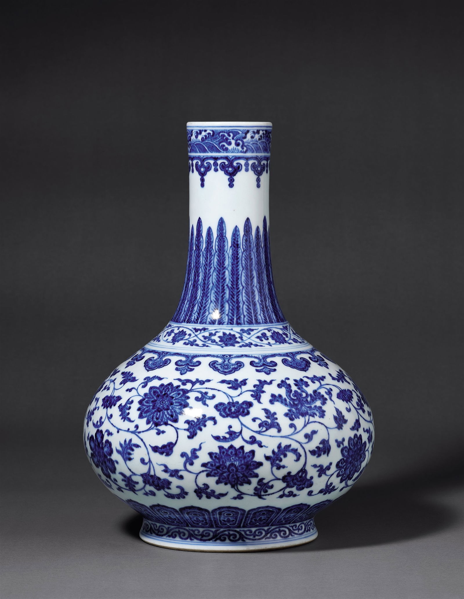 A BLUE-AND-WHITE BOTTLE VASE WITH FLORAL SCROLLS (1 of 1)