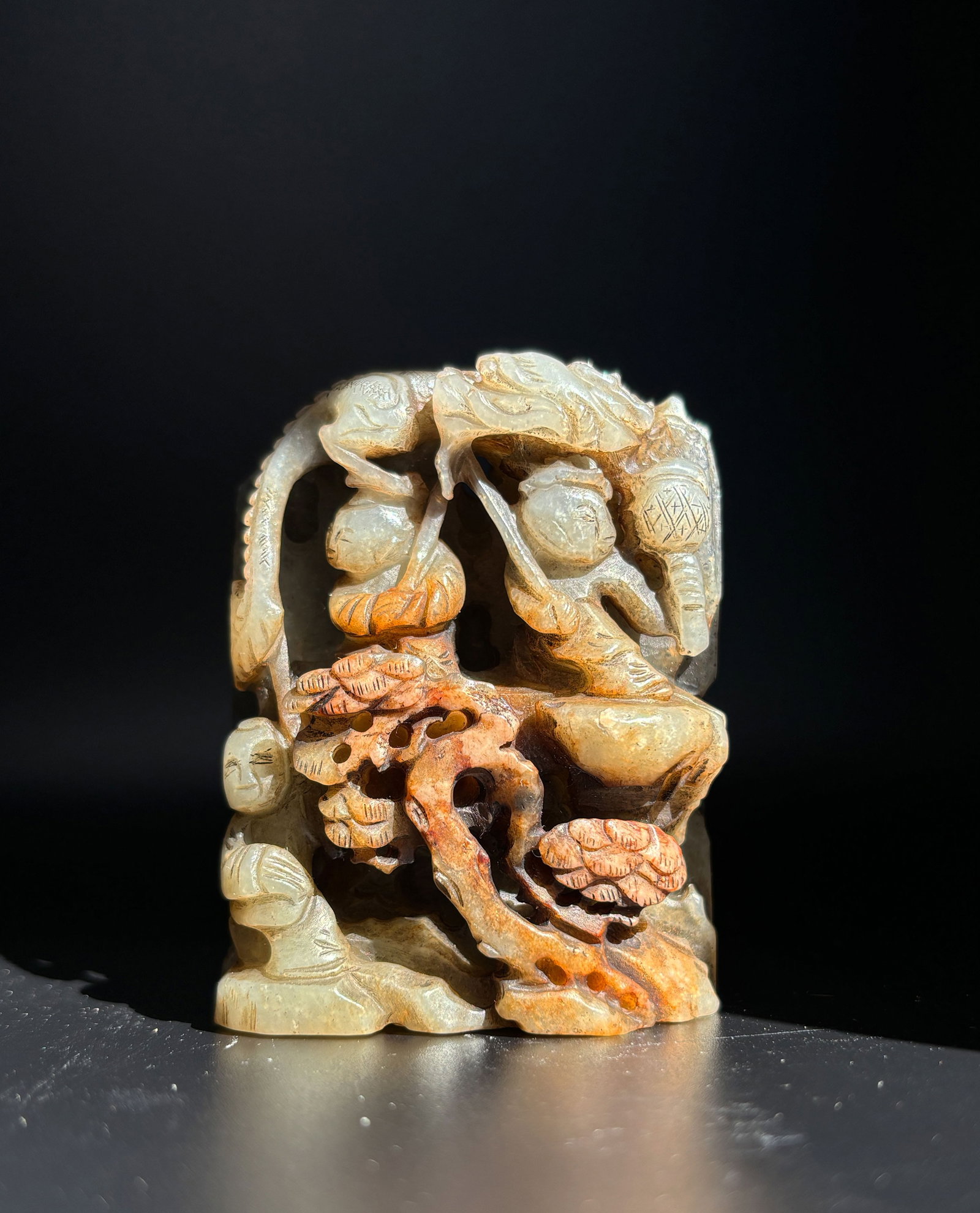 Jade Russet Carved Figure and Landscape: High relif, H: 6.4cm, W: 5.4cm 玉透雕山子帶皮 高浮雕，高6.4釐米, 寬5.4釐米 The Condition report's 