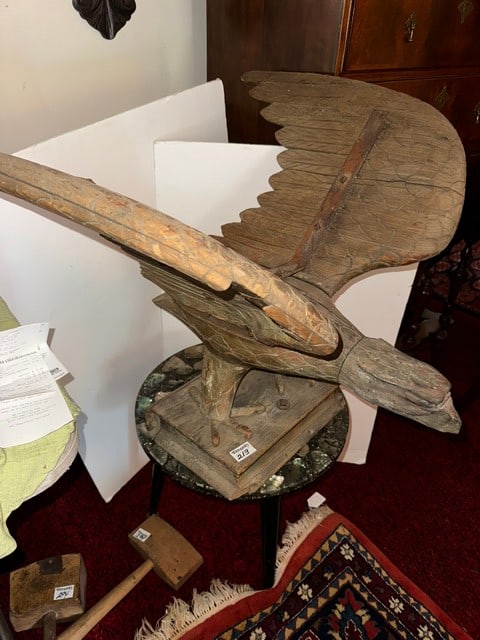 CARVED WOODEN EAGLE STANDING ON BOOK (MISSING TAIL): 29" WING SPAN, 22" BEAK TO TAIL, 25"H