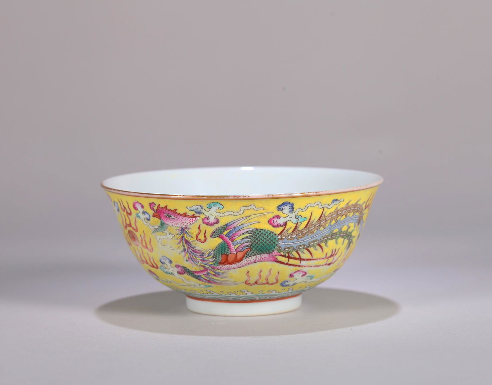 A yellow ground famille rose dragon and phoenix porcelain bowl (1 of 6)