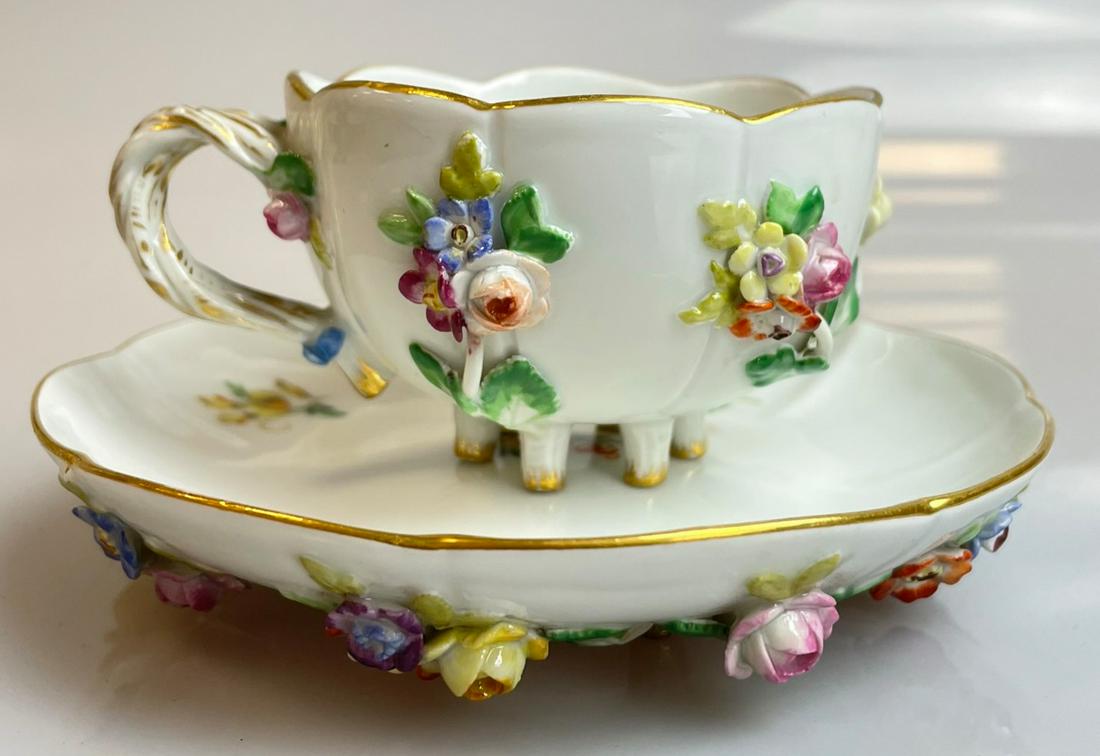 Antique Meissen splendour mocca cup with splendour saucer.: The cup is circa 5 cm high. Porcelain. Diameter of the saucer circa 12 cm. Blue sword mark on the underside. Condition: saucer minimally bumped in one place. See photo.