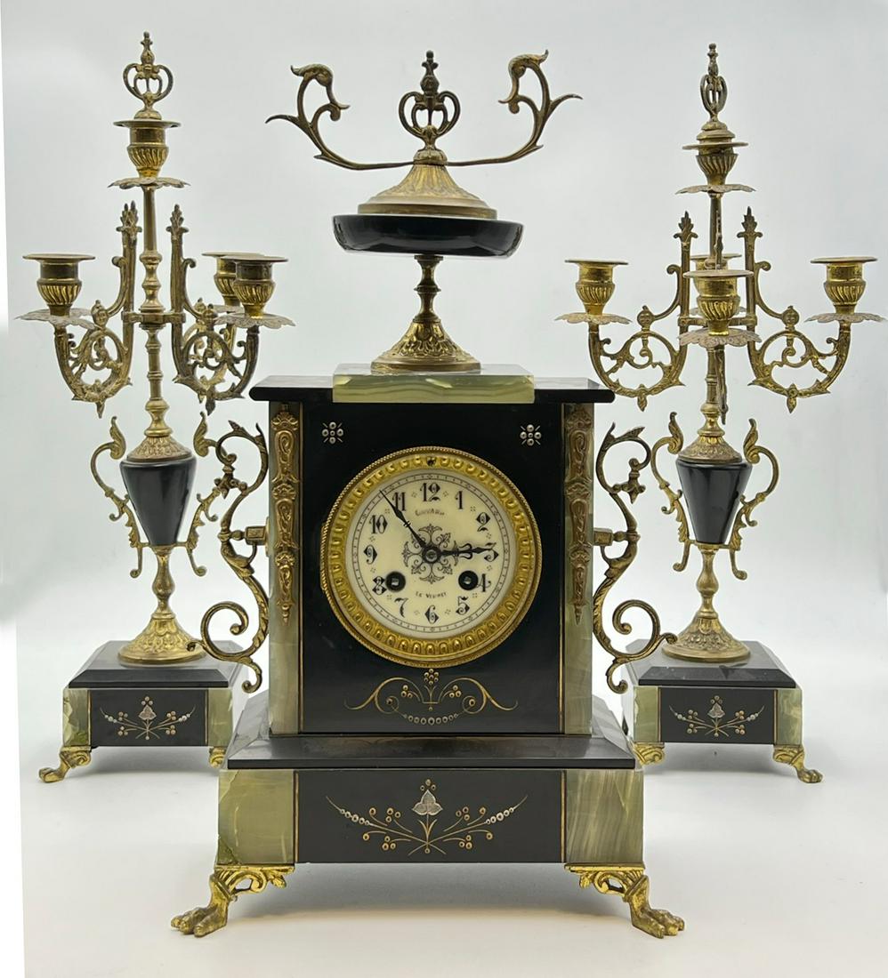 Fireplace clock with 2 side plates as 5-flame candlesticks. 19th century, France,: Candlestick up to 49 cm high. The clock up to 45 cm high. Glass present. Inscribed: ''Goyard - Le Vesinet''.