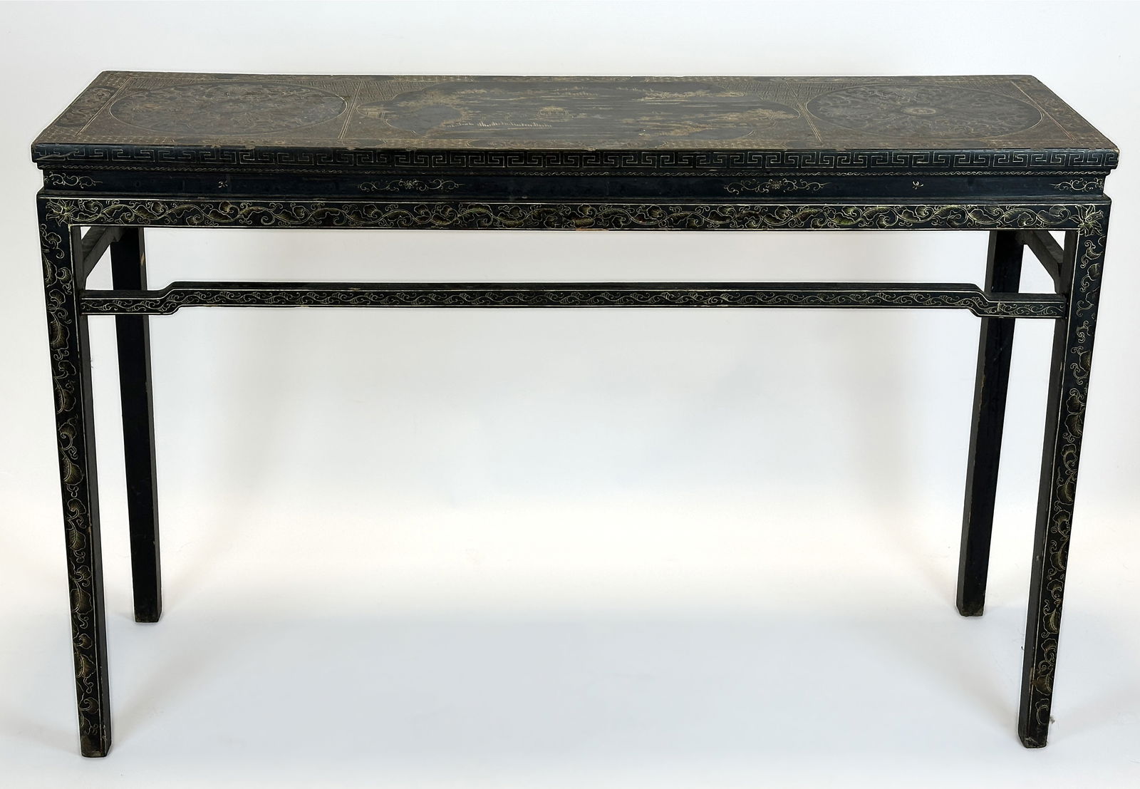 Holzkonsole. China. Um 1900. Wooden console table. China. Circa 1900.: Approx. 82 cm x 125 cm x 38 cm. Wooden console table. Painted black and gold. Richly decorated with floral patterns and Chinese cityscapes. Some areas of paint loss. Signs of wear due to age. Conditio