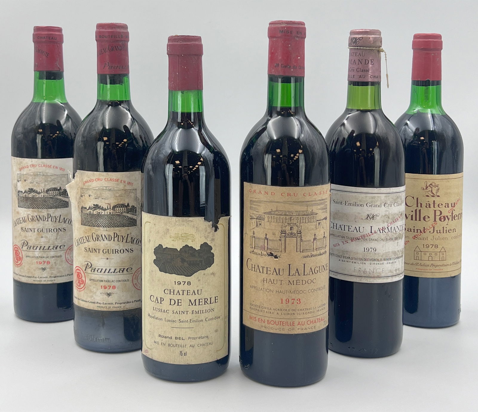 6 bottles of red wine. Château. Various varieties. 1970s.: 0.75 L each. 1 bottle of 1973 Château La Lagune. Haut Medoc. Grand Cru Classe. 2 bottles of 1978 Château Grand Puy Lacoste St. Guirons. Pauillac. 1 bottle of 1978 Château Leoville Poyfe