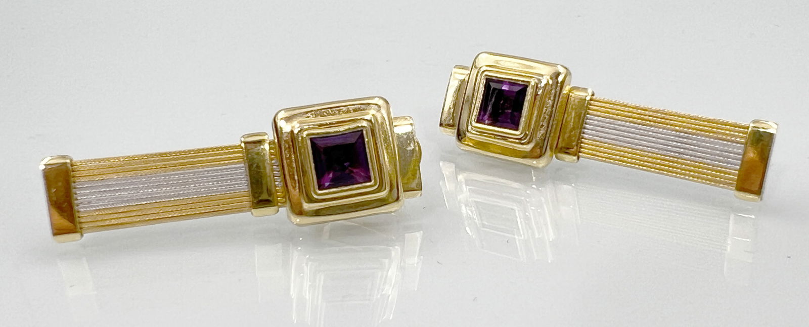 Two-tone stud earrings. 750 yellow gold and white gold with a purple gemstone. (1 of 6)