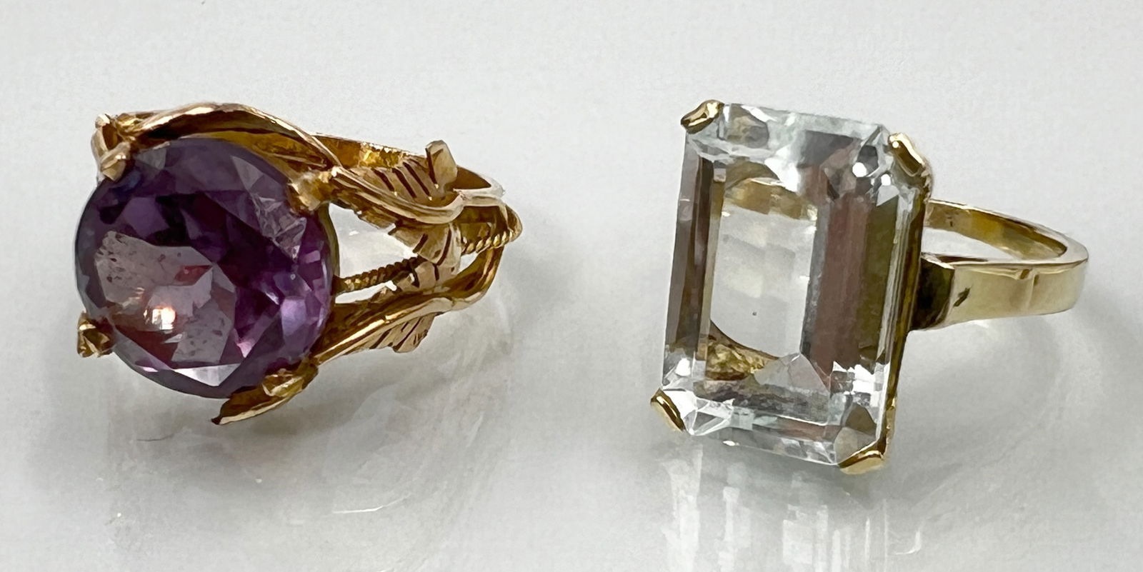 Two solitaire rings. 585 yellow gold with an aquamarine and a purple coloured stone. (1 of 8)