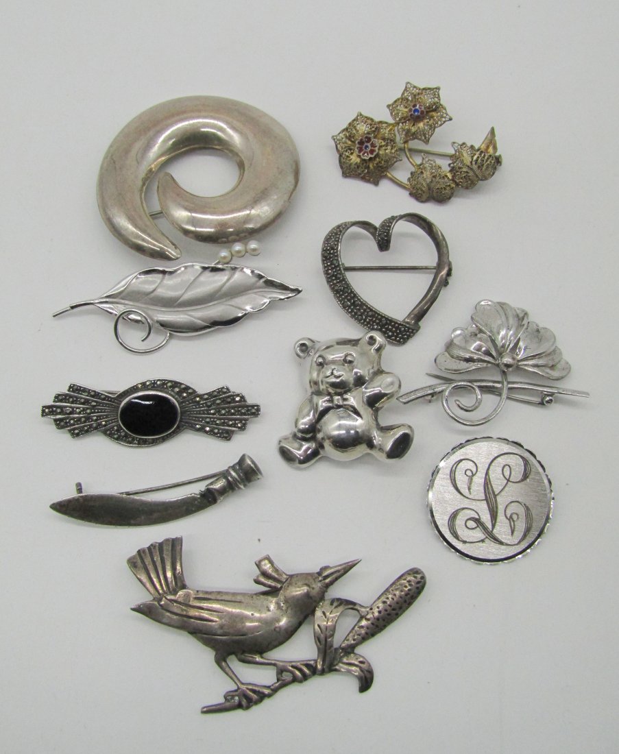 estate lot of 10 vintage sterling pins, brooches: nice grouping of sterling pins. to include heart. teddy bear, bird, marcasite, etc. weighs 73.5 grams.