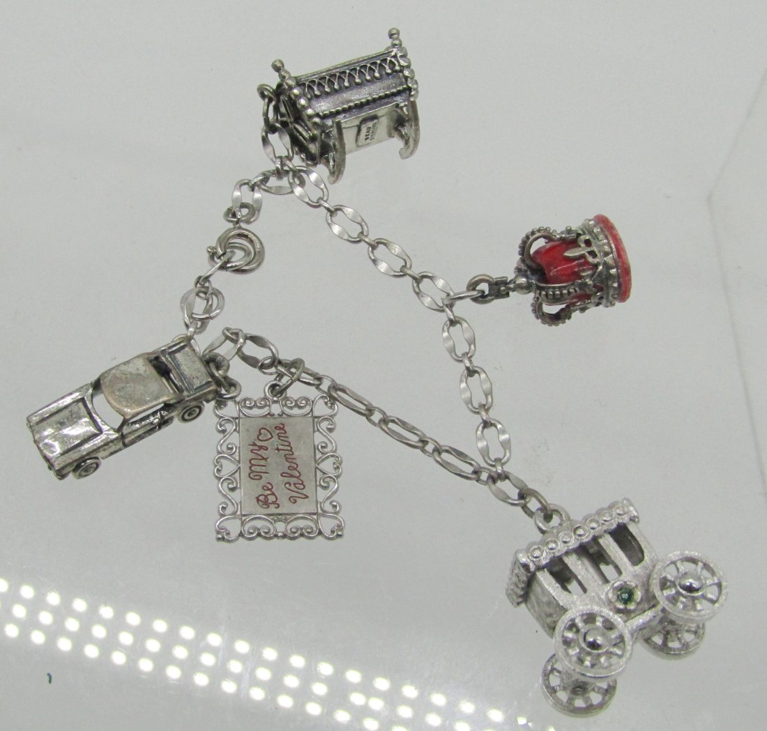 estate sterling charm bracelet with 5 charms: nice charm bracelet with 5 charms. weighs 28.8 grams.